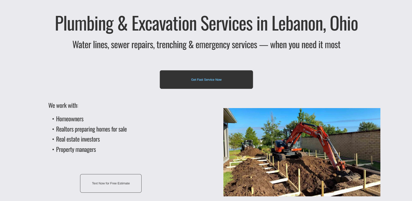 Construction site with an orange excavator digging trenches in a backyard, framed by a brick wall and a house, with trees and blue sky in the background.