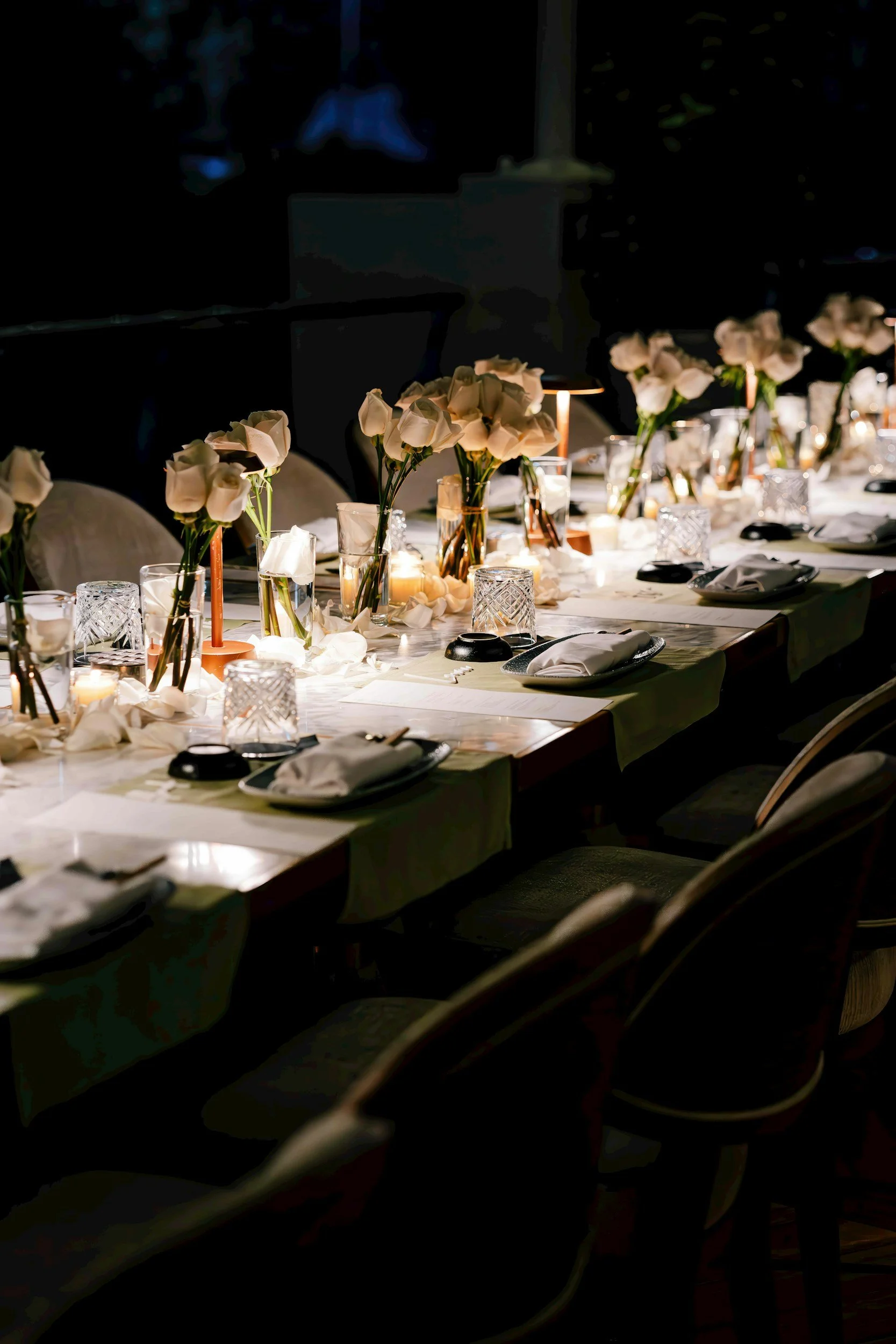 Elegant dinner party table setting with candles and flowers at a private villa in Mallorca for an exclusive culinary evening.