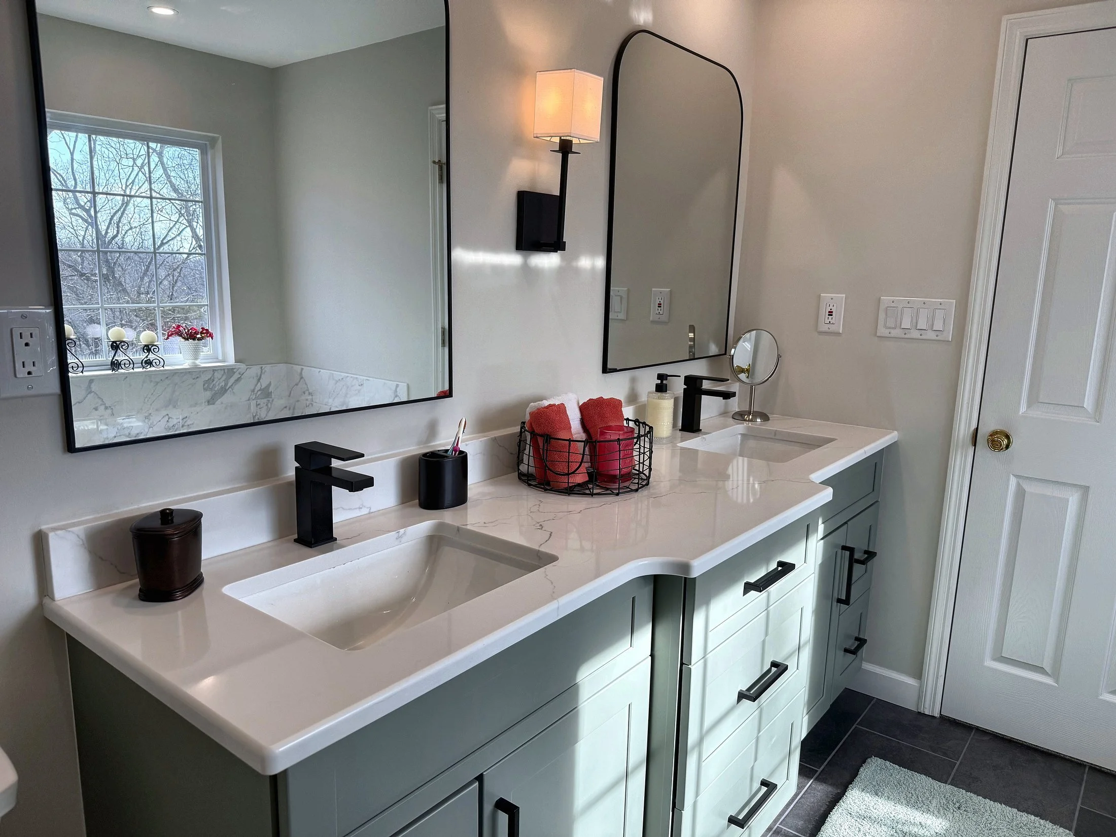Vanity with arched mirrors and black faucets