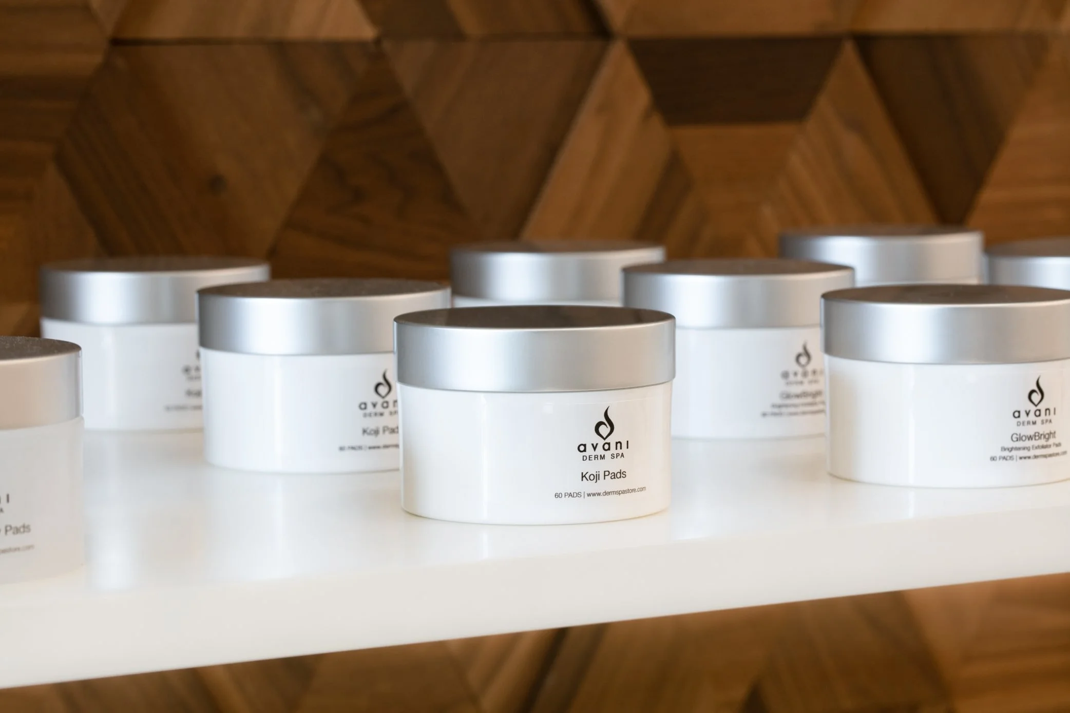 Product shelves against a geometric wood wall