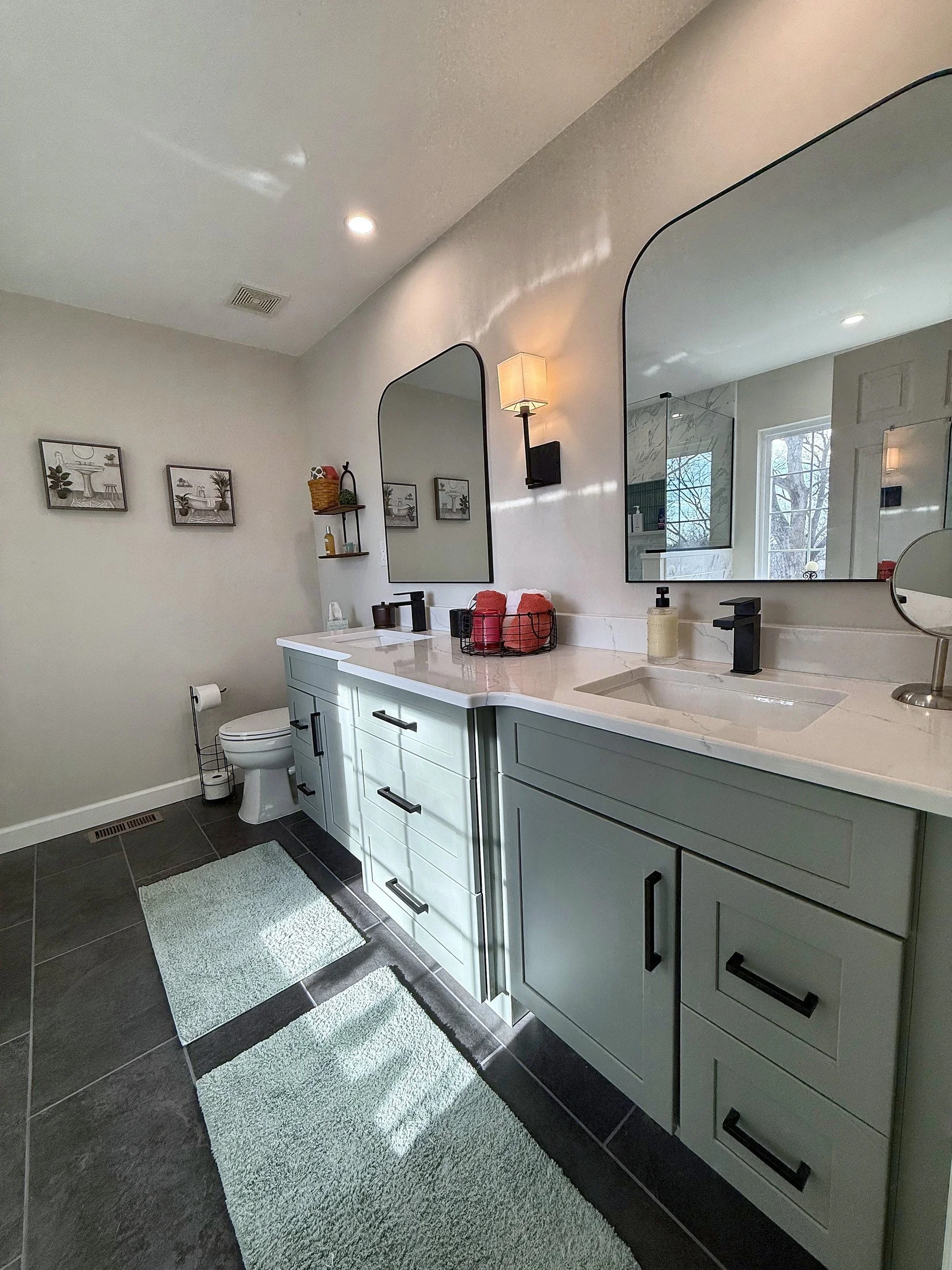 Vanity with arched mirrors and wall sconces