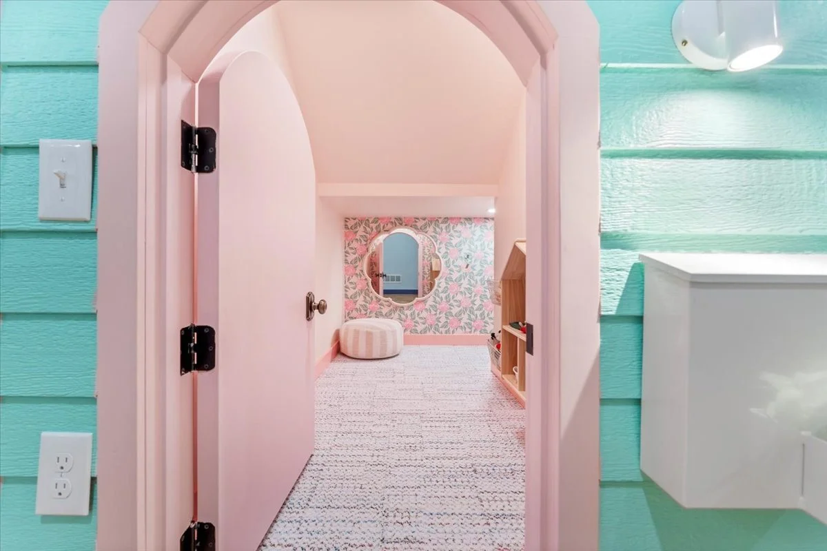 Arched doorway into a pink play space