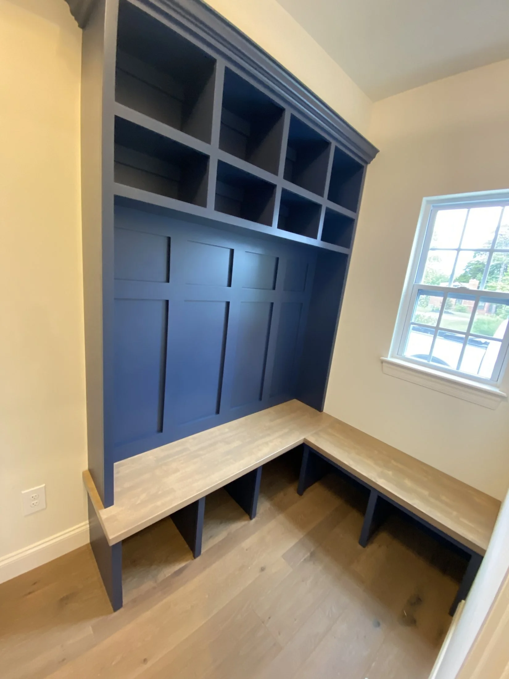 L-shaped mudroom bench with navy lockers