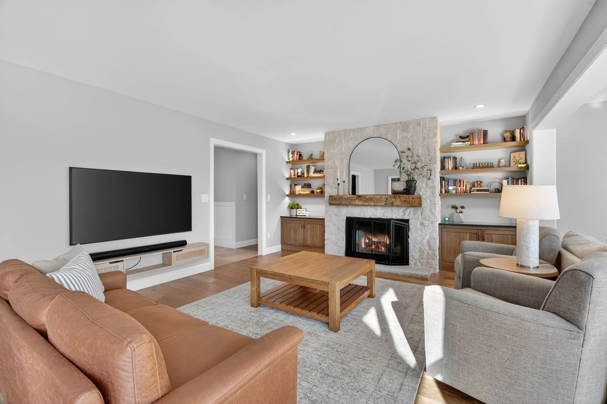 Family room with a stone fireplace and built-ins