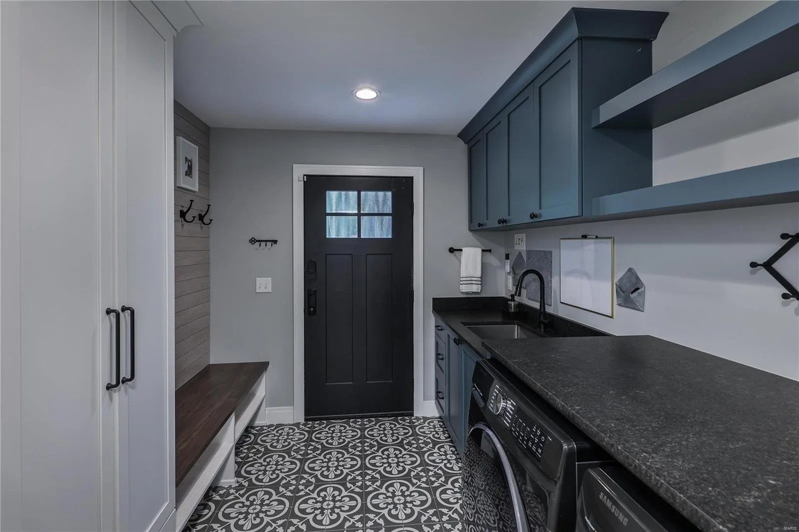 Mudroom with a built-in bench and laundry