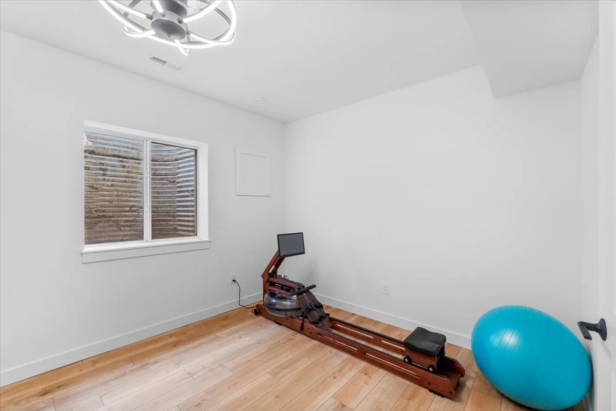 Basement home gym with a rowing machine