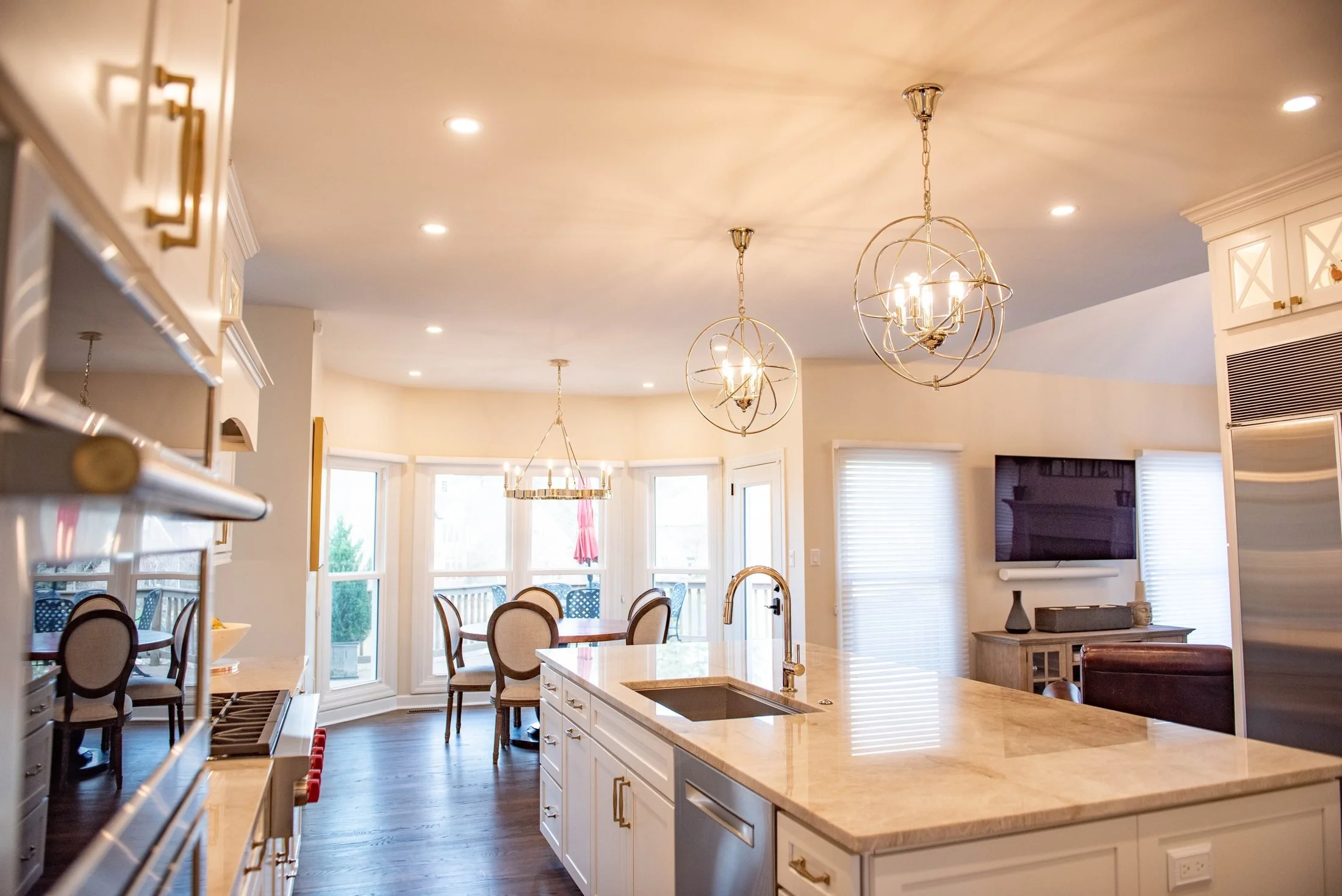 Kitchen island and breakfast area with bay windows