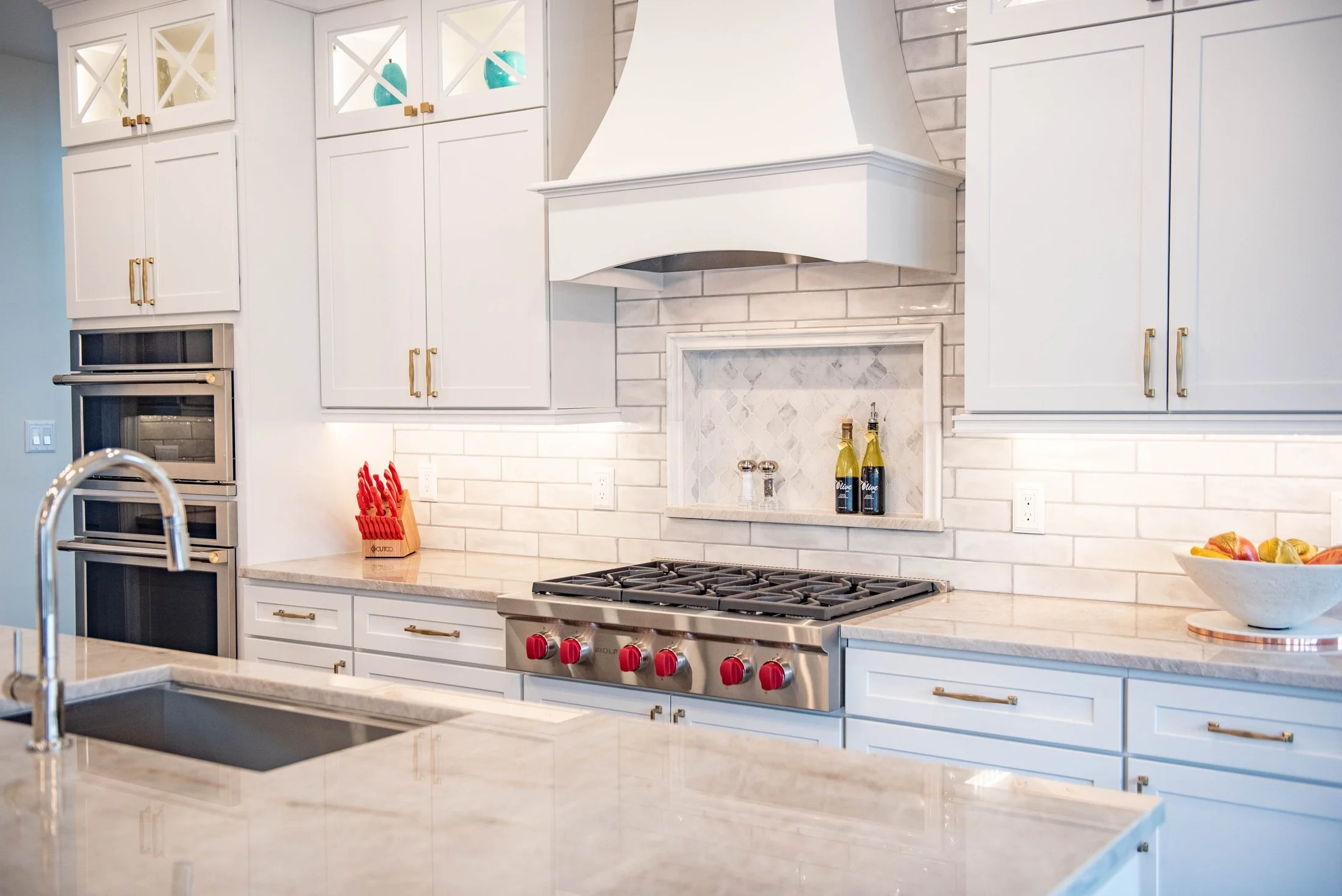 Custom range hood with a subway tile backsplash