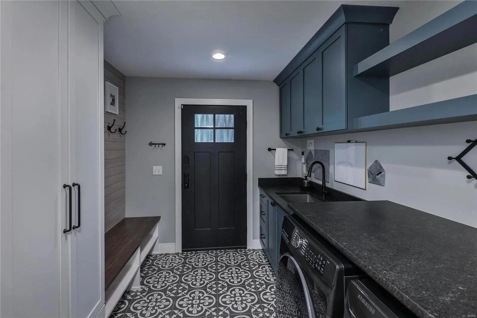 Mudroom with a built-in bench and laundry