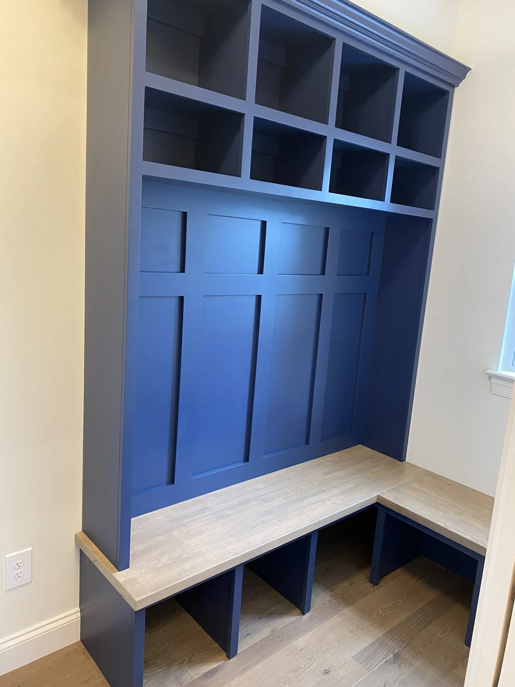 Navy mudroom lockers with upper cubbies and a bench