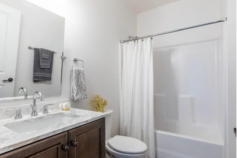 Loft bathroom with a dark vanity