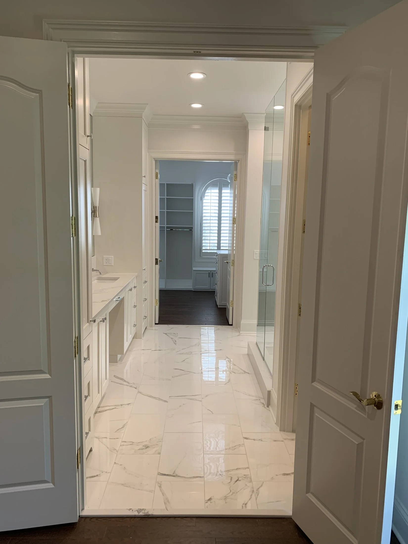 Entry into a marble-look tile primary bath