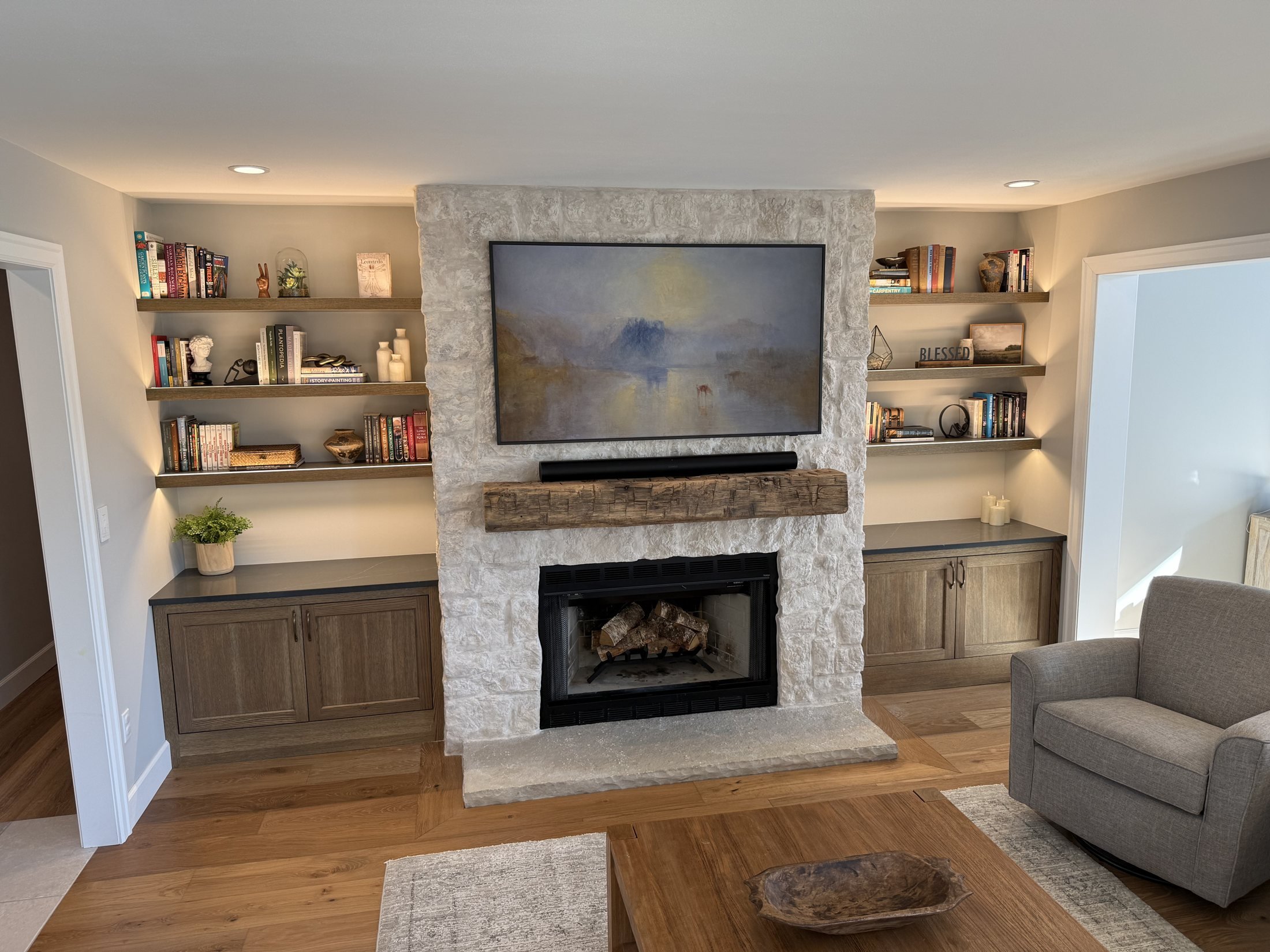 Stone fireplace wall with flanking built-ins