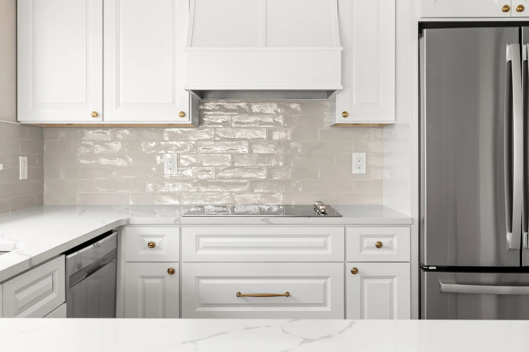White range hood with a glossy tile backsplash
