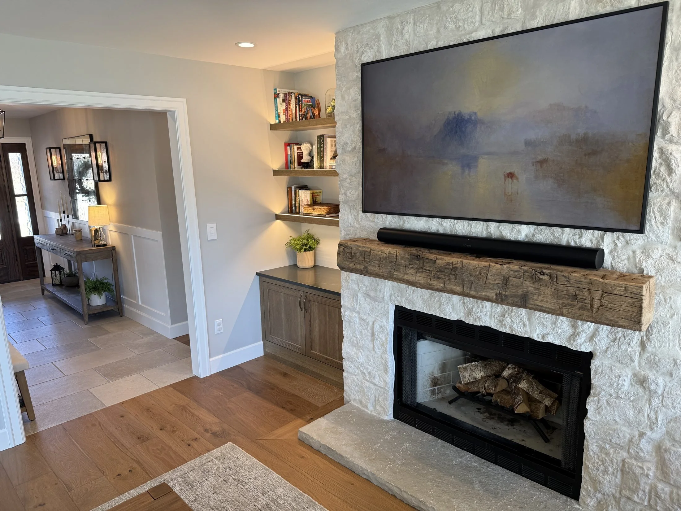 Stone fireplace with a rustic wood mantel