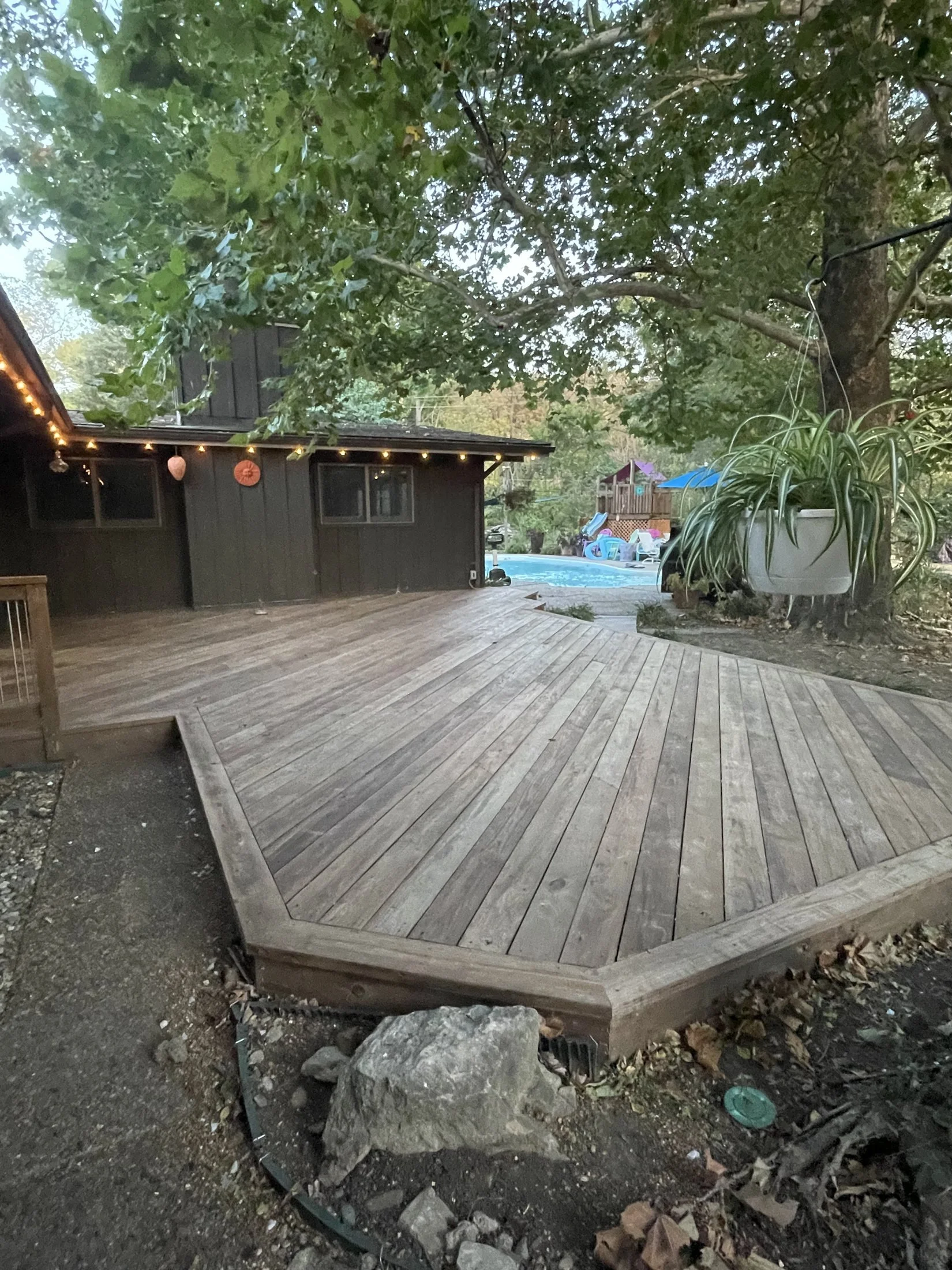 Low wood deck wrapping the house