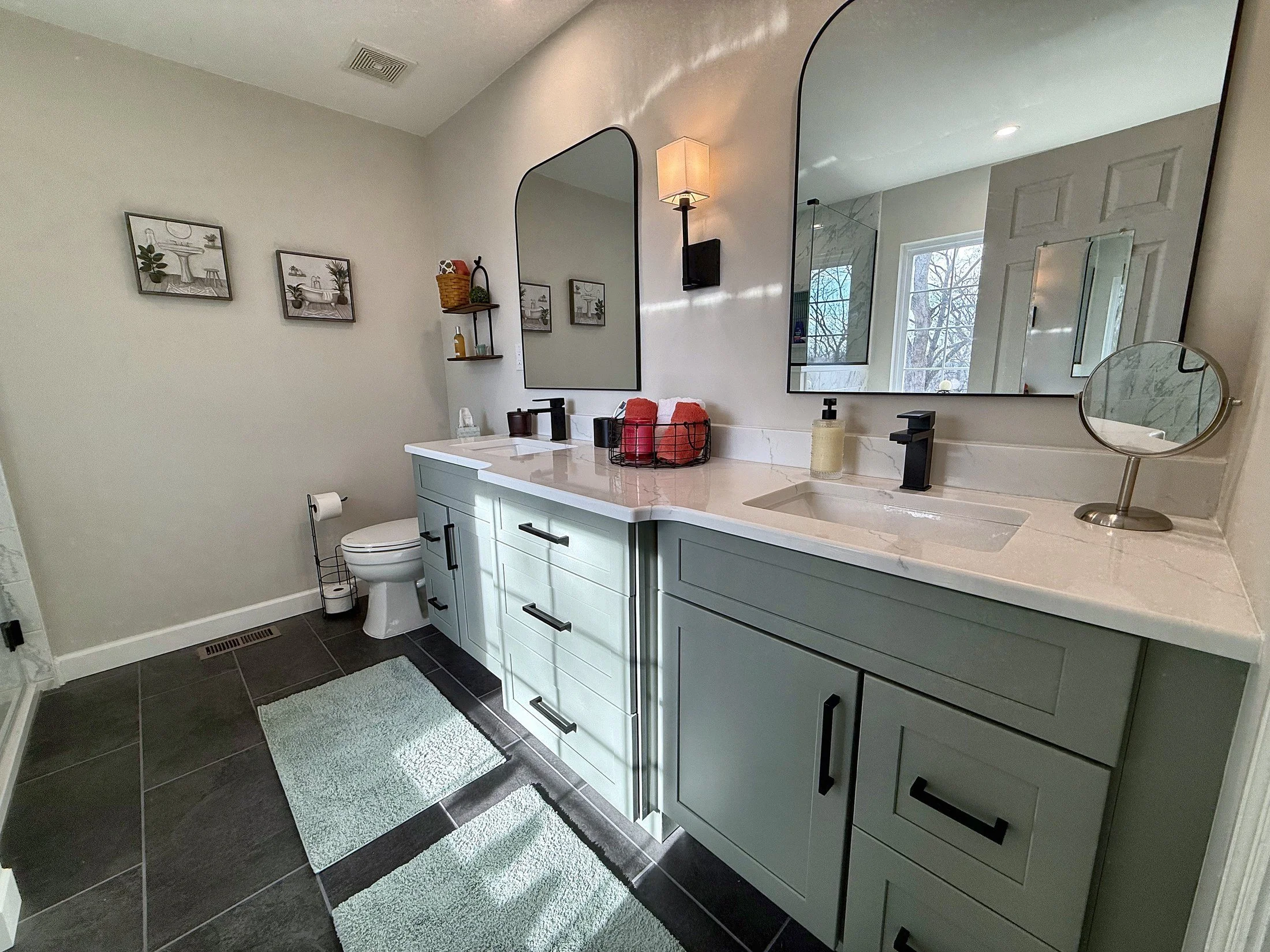 Painted double vanity with arched mirrors and matte black faucets