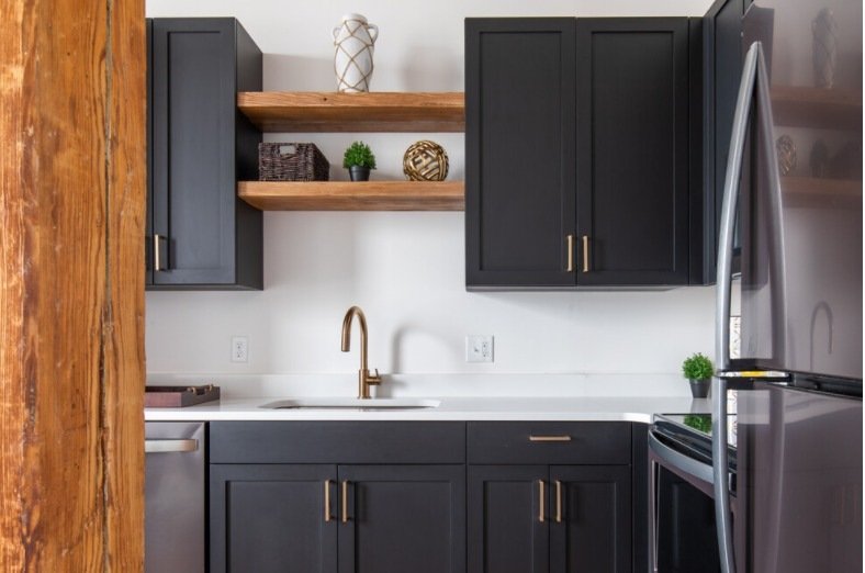 Kitchen with open wood shelving beside a timber column