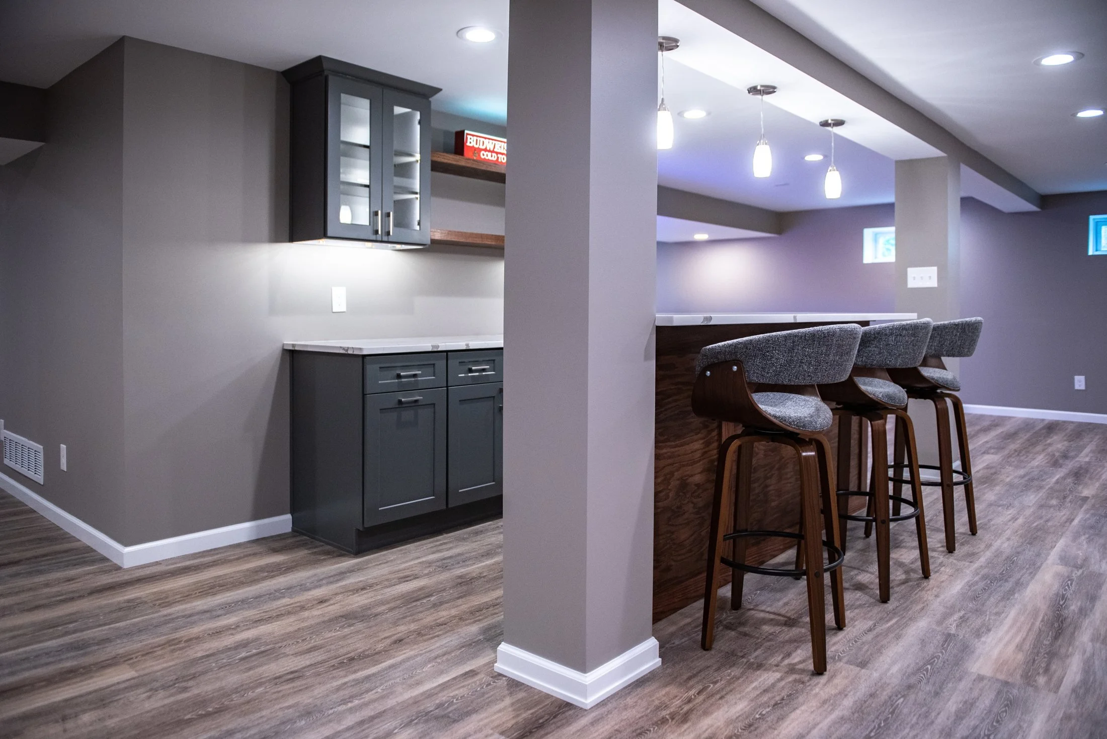 Bar seating at a quartz-topped basement island