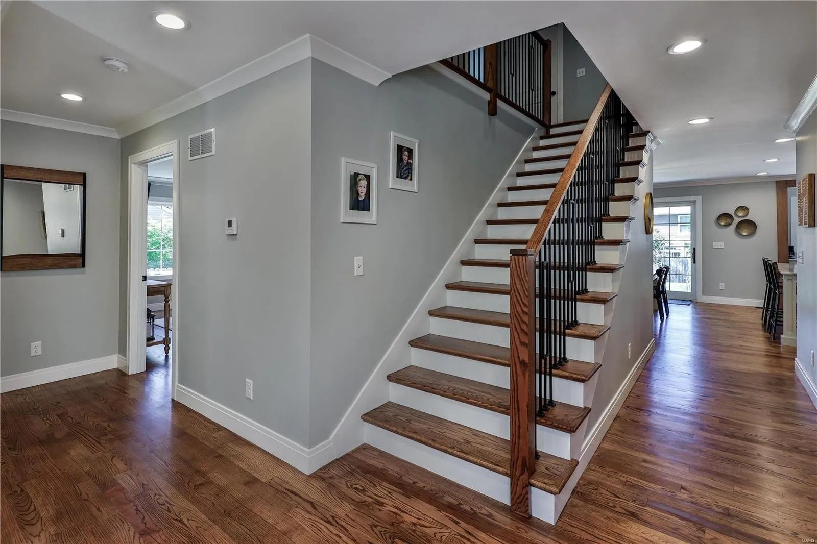 Open staircase with wood treads and black iron balusters