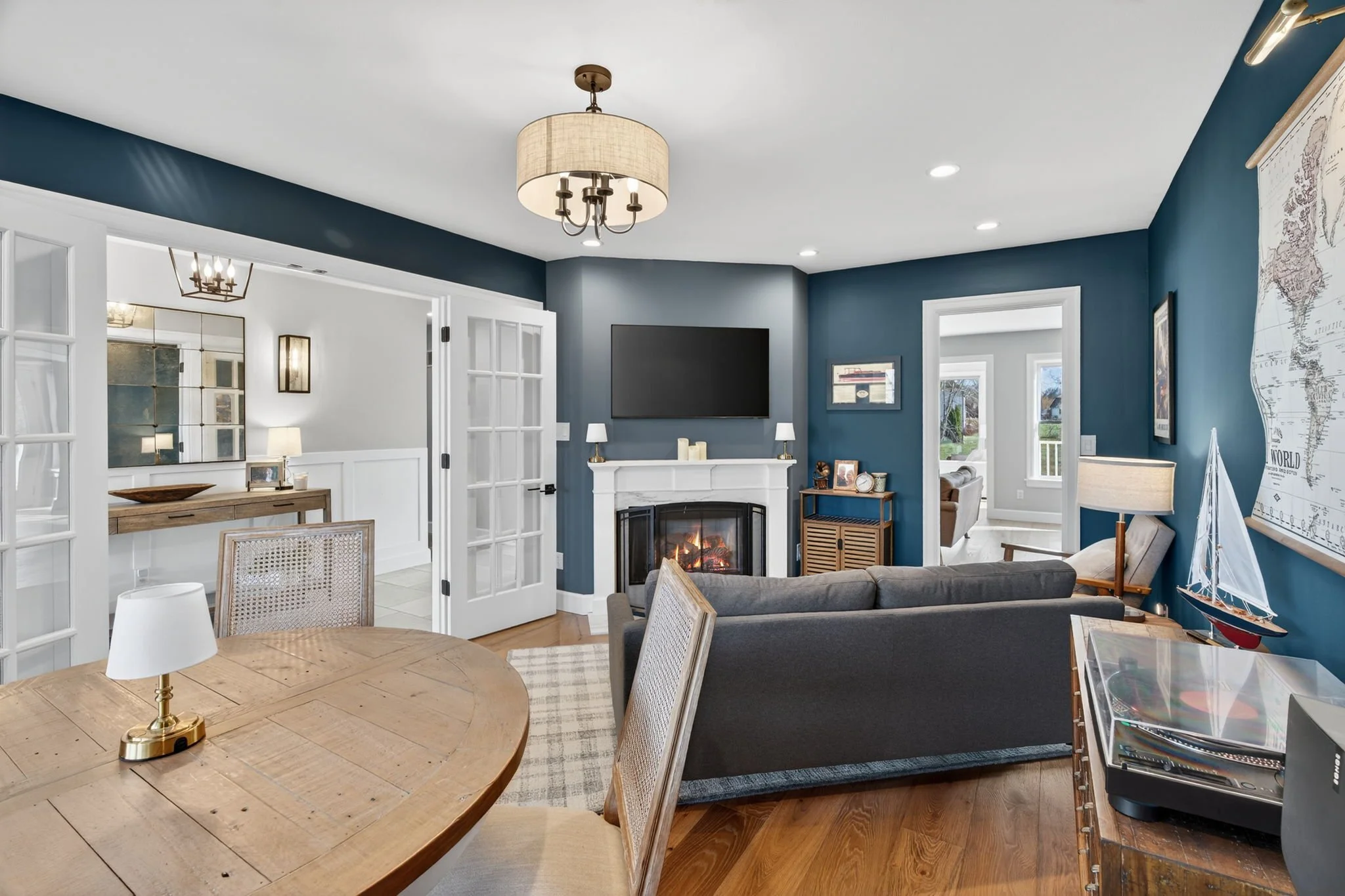 Sitting room with a fireplace and built-in TV wall