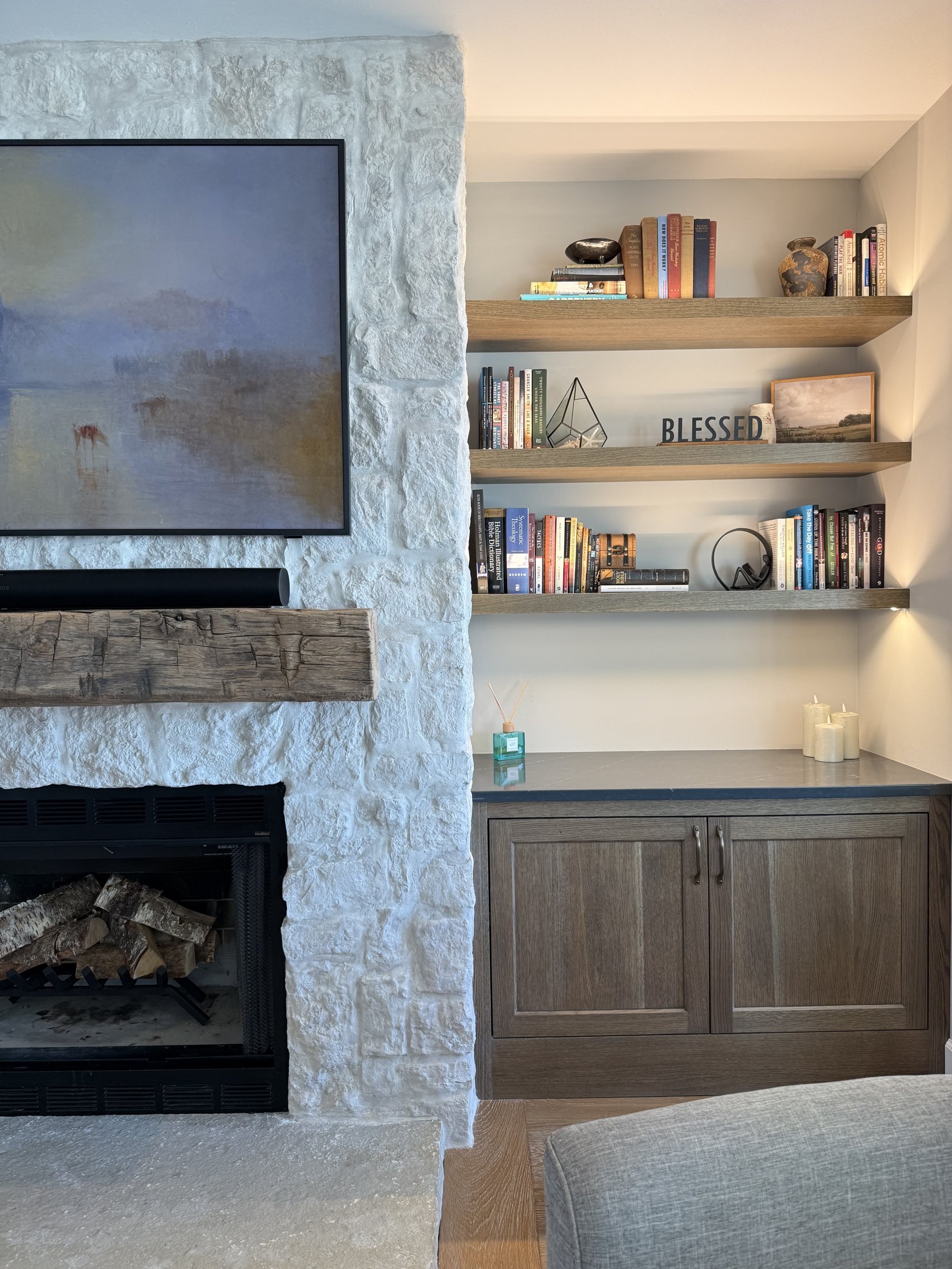 Lit floating shelves above built-in cabinets