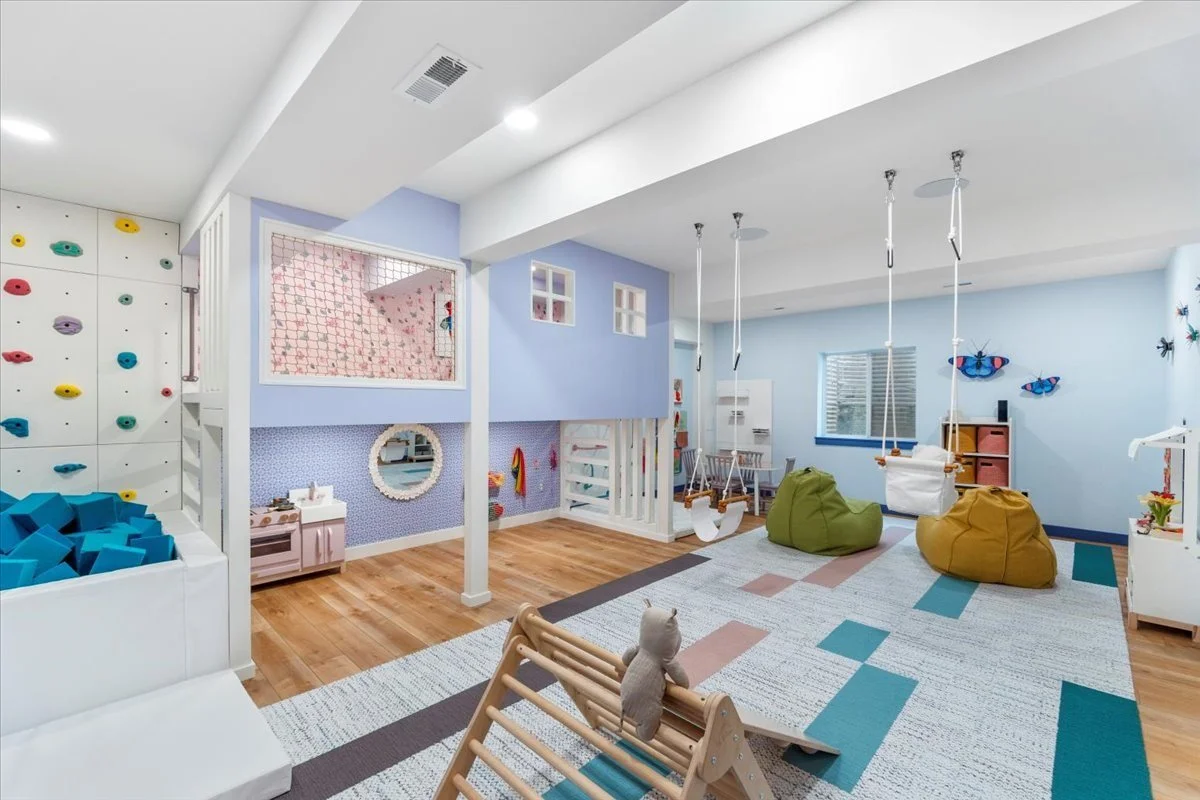 Playroom with a climbing wall and swing