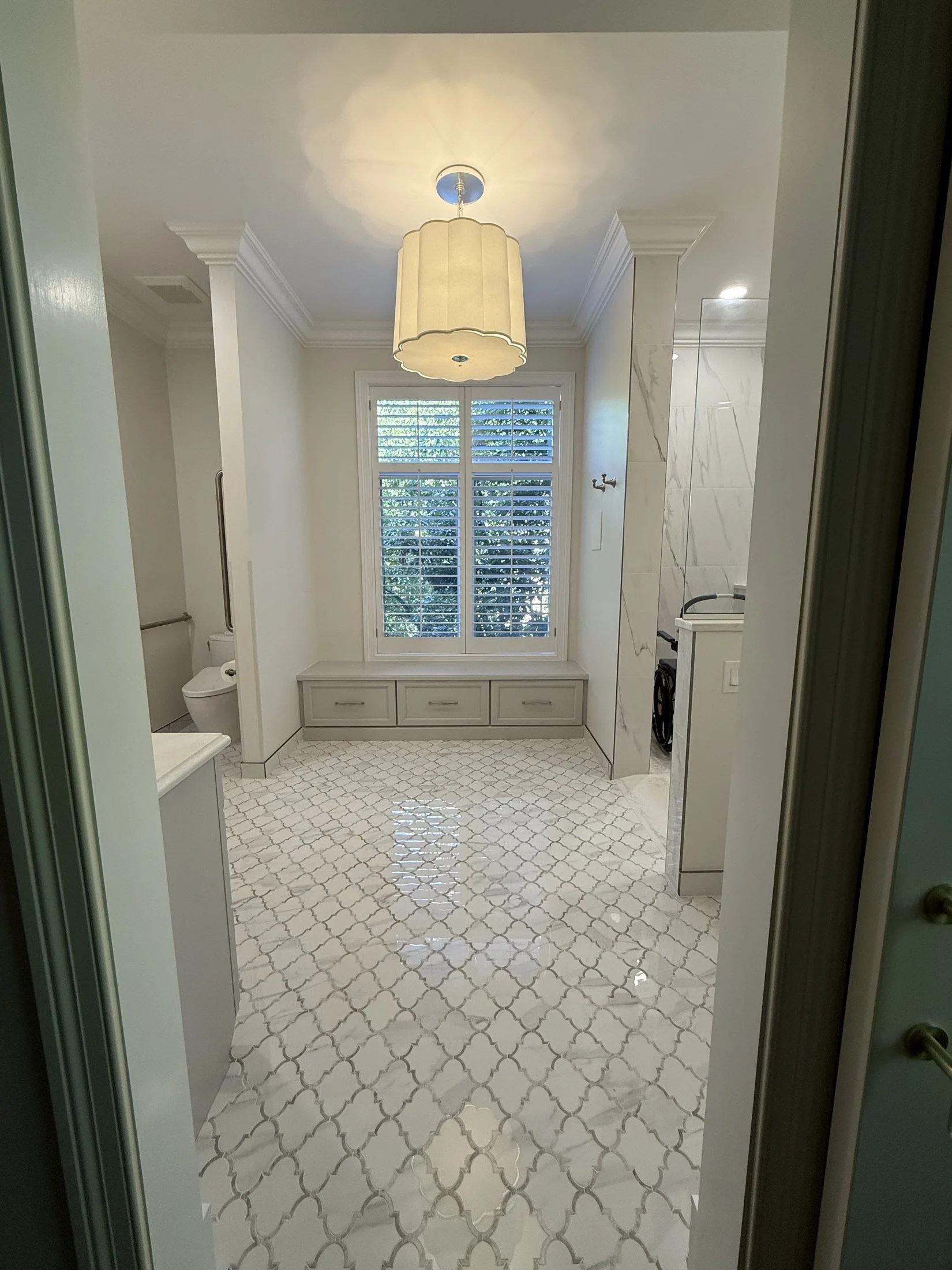 Entry view of a marble-look primary bath