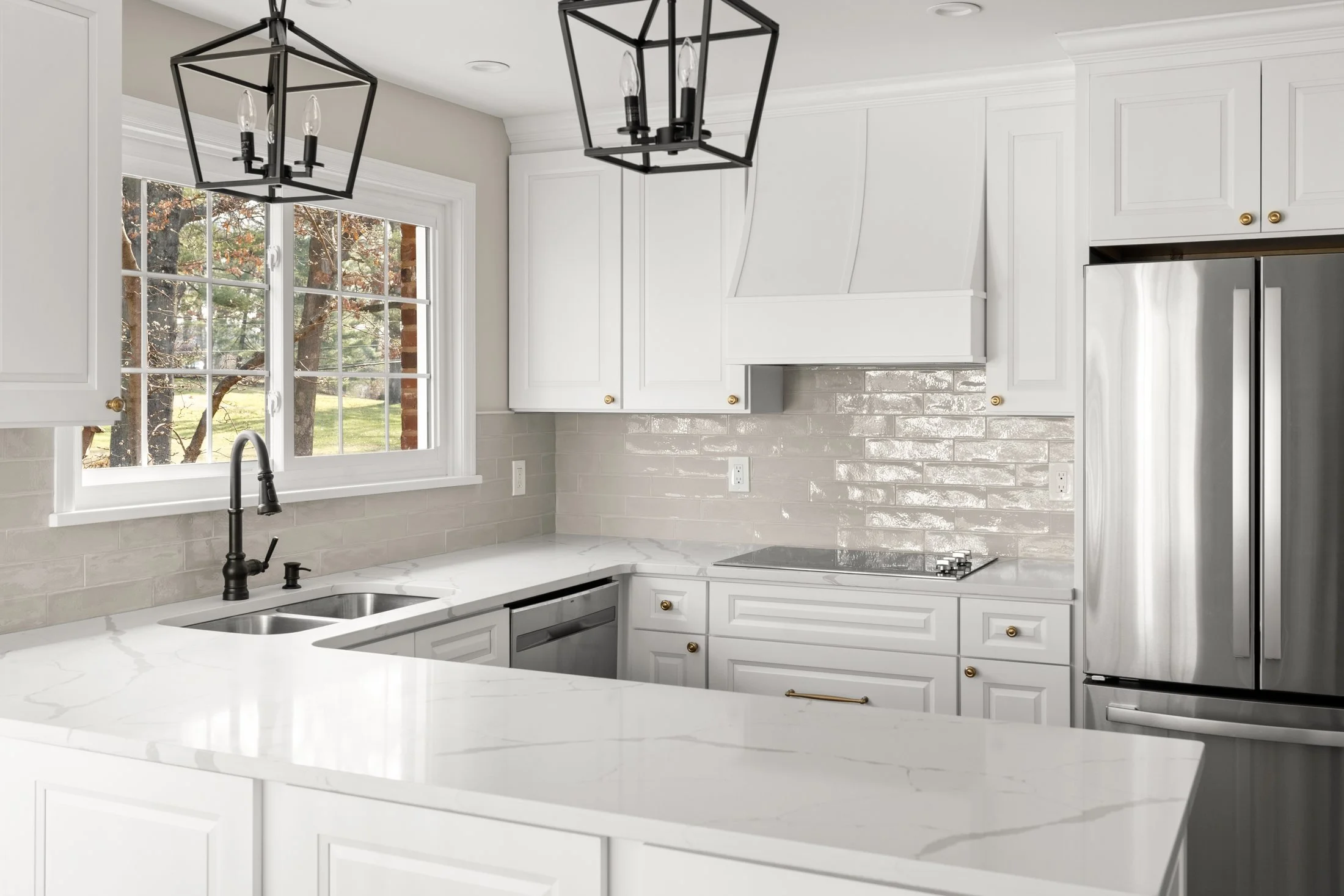 Lantern pendants over a white kitchen
