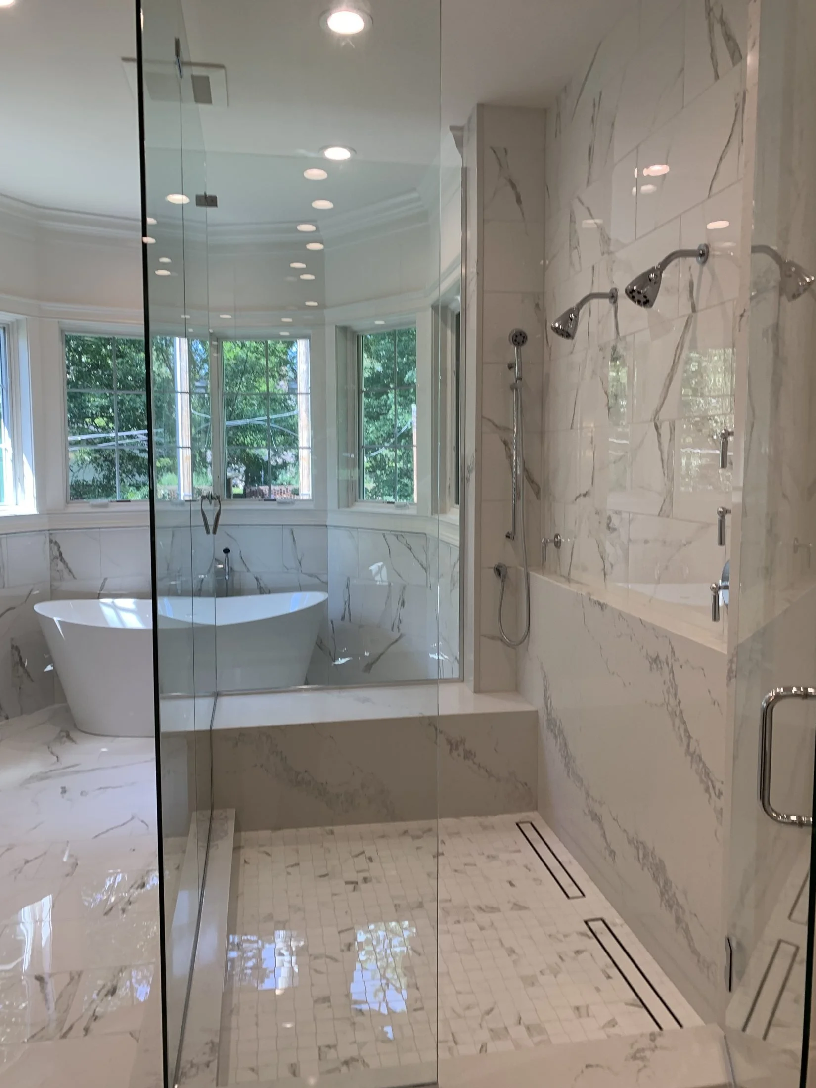 Glass shower beside the freestanding tub