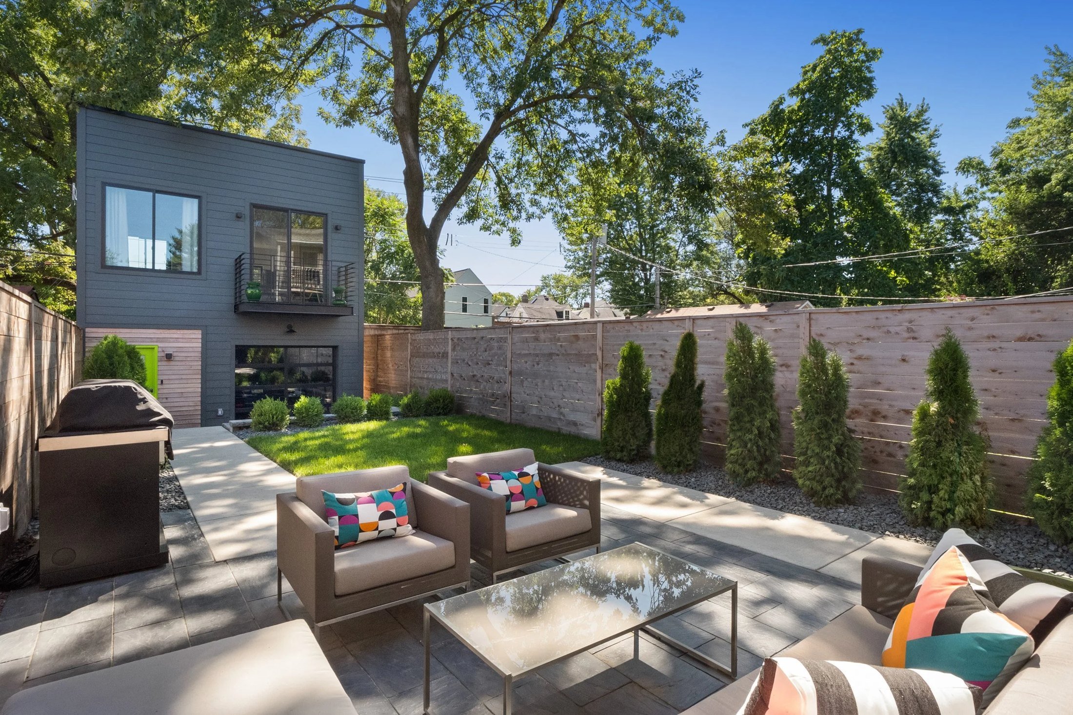 Patio with lounge seating and an arborvitae privacy screen