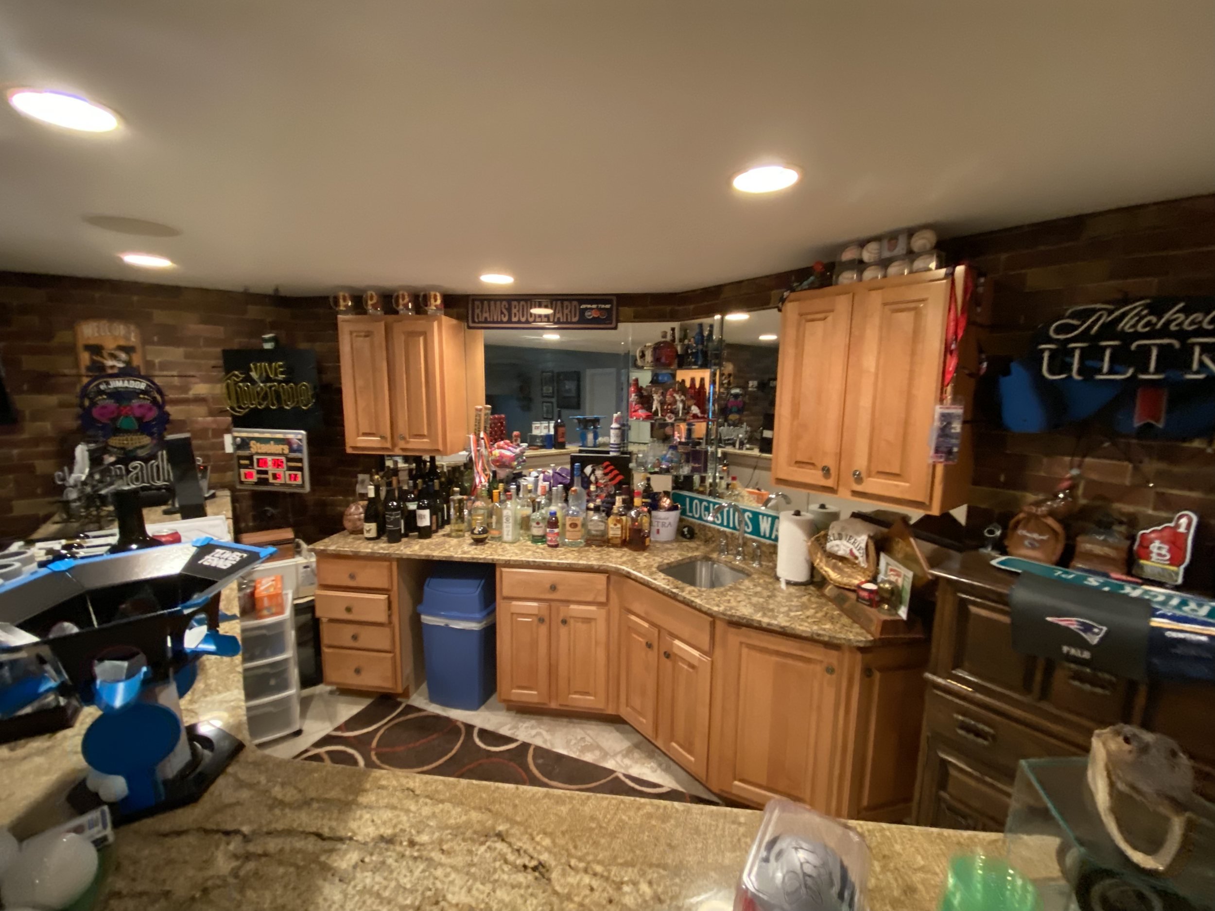 Wet bar with oak cabinets and a granite counter before the remodel