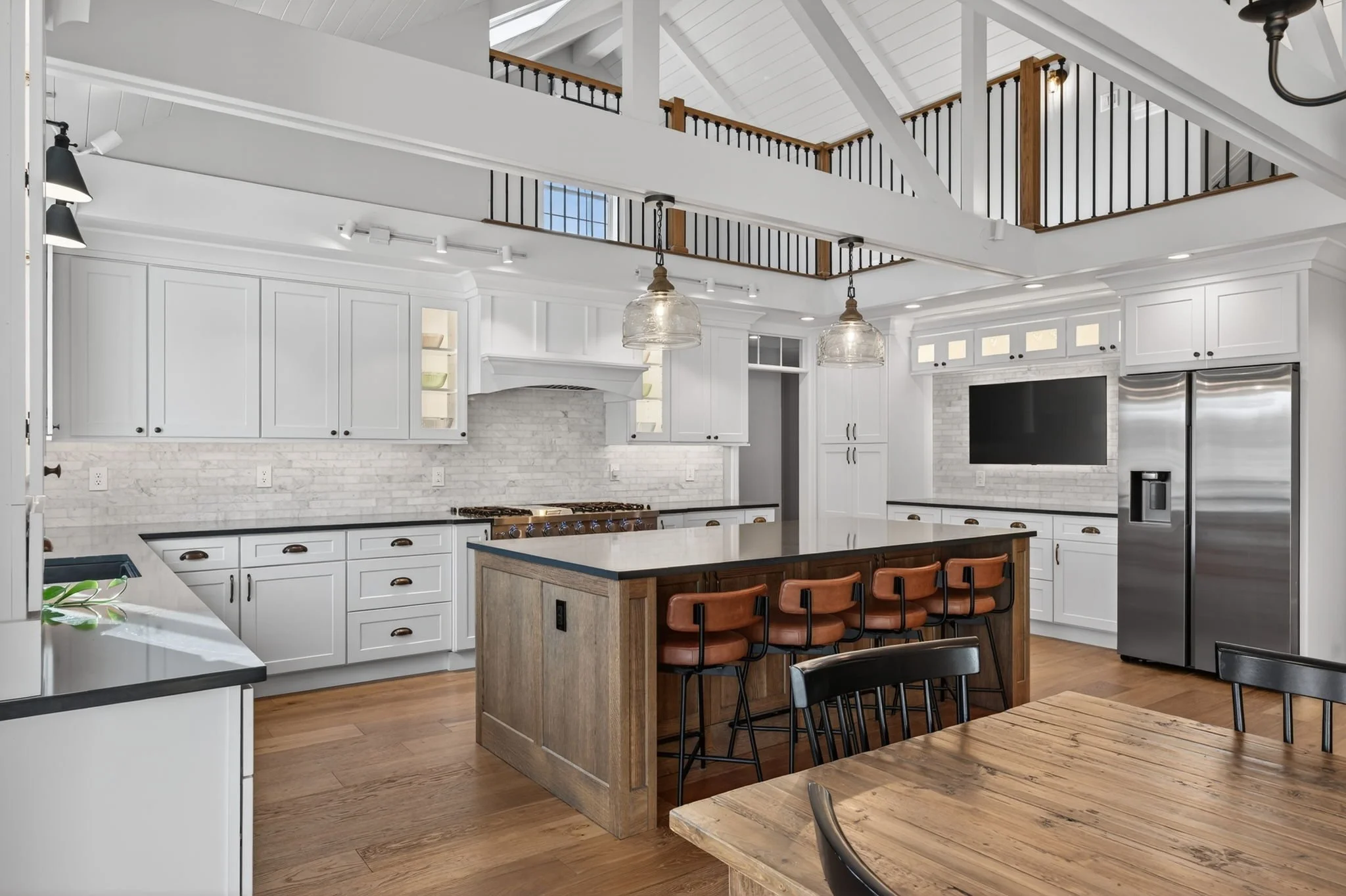 Stained wood island under a vaulted, beamed ceiling