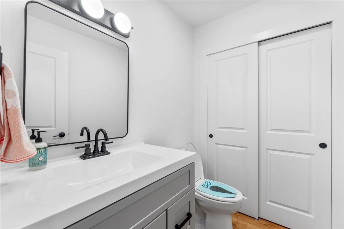 Basement bathroom with a gray vanity