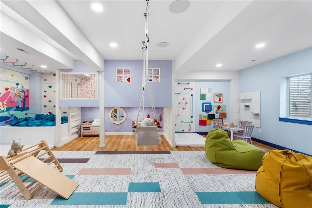 Basement playroom with a climbing wall and bean bags