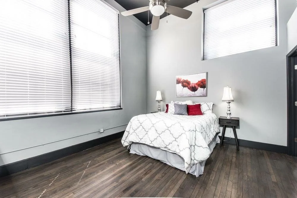 Loft bedroom with tall windows