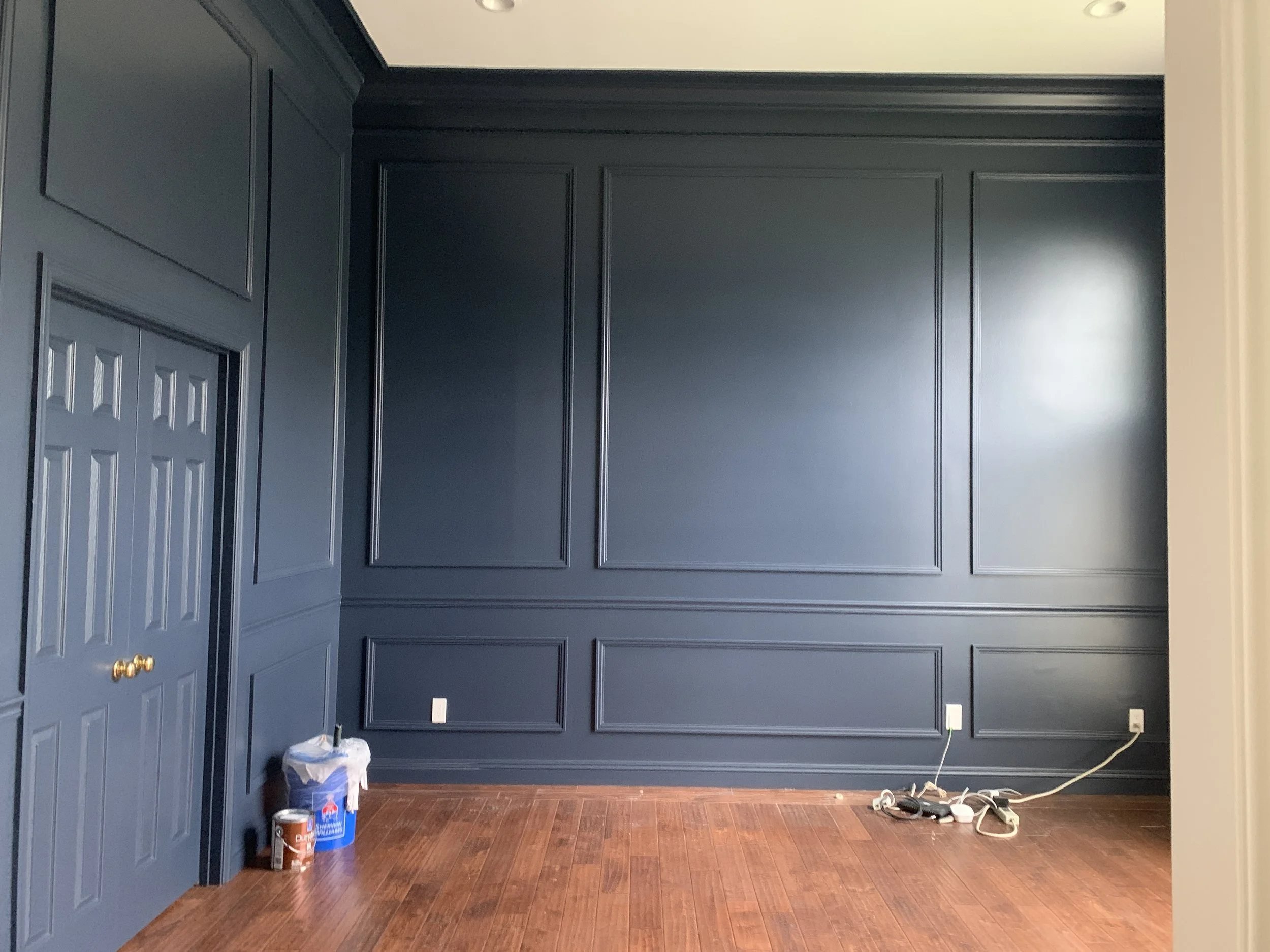 Navy painted wall paneling in a home office