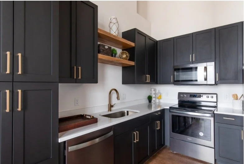 Loft kitchen with dark cabinetry and open shelving