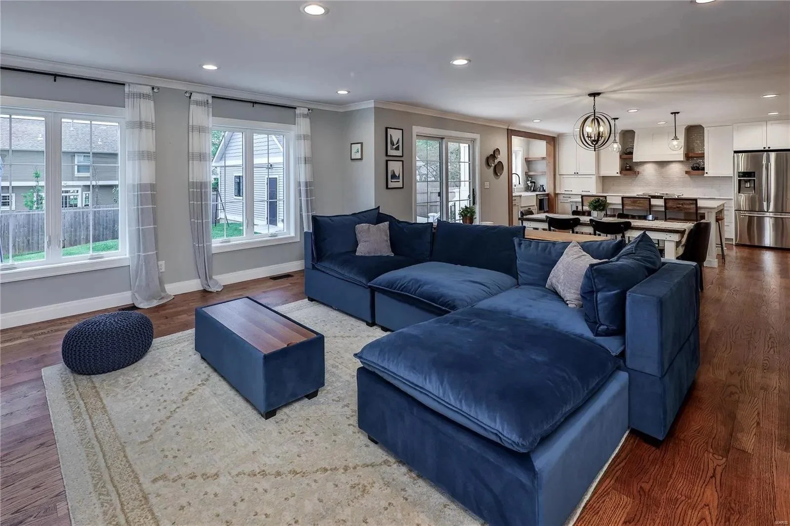 Family room with a fireplace and wall of windows