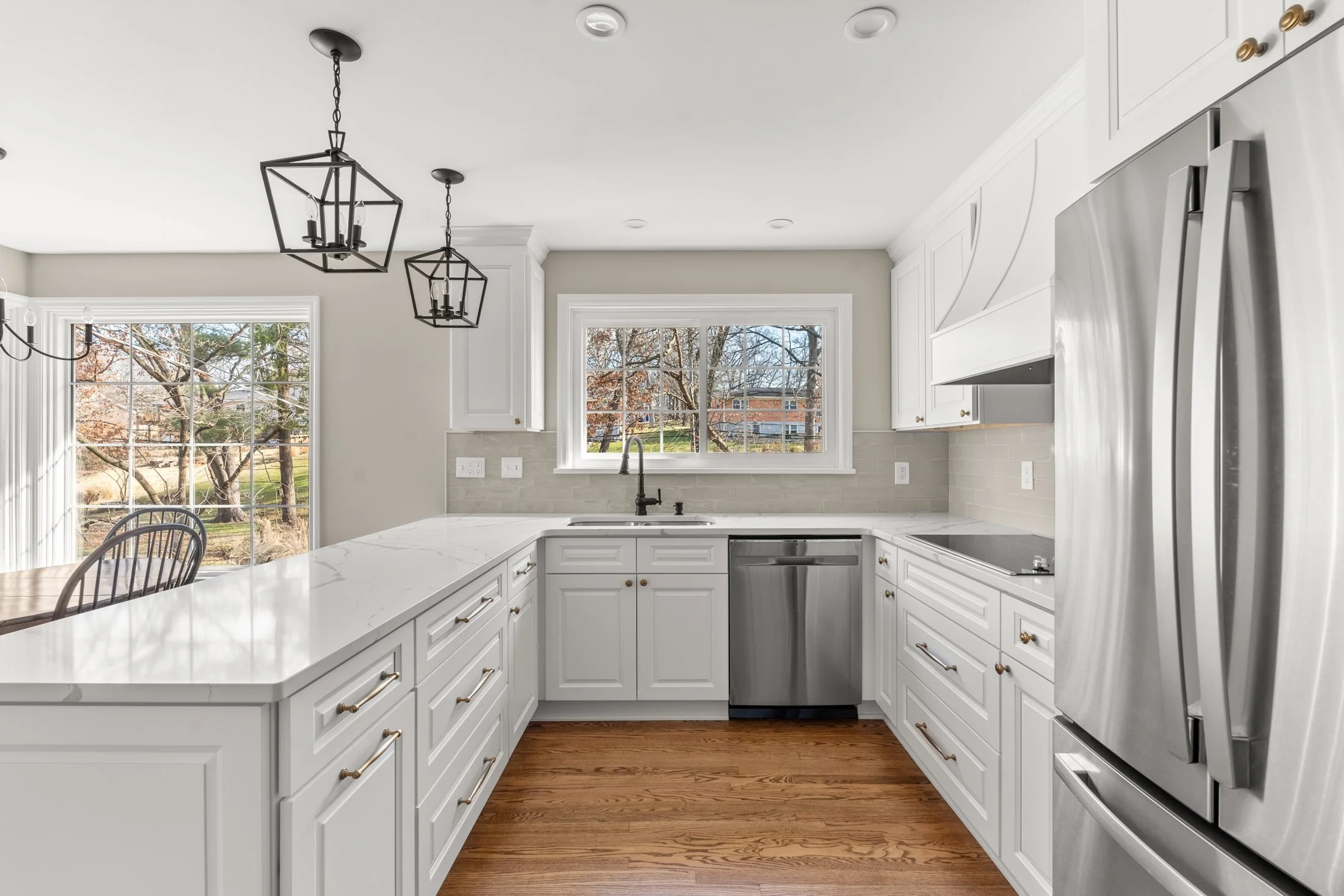 U-shaped white kitchen with quartz countertops