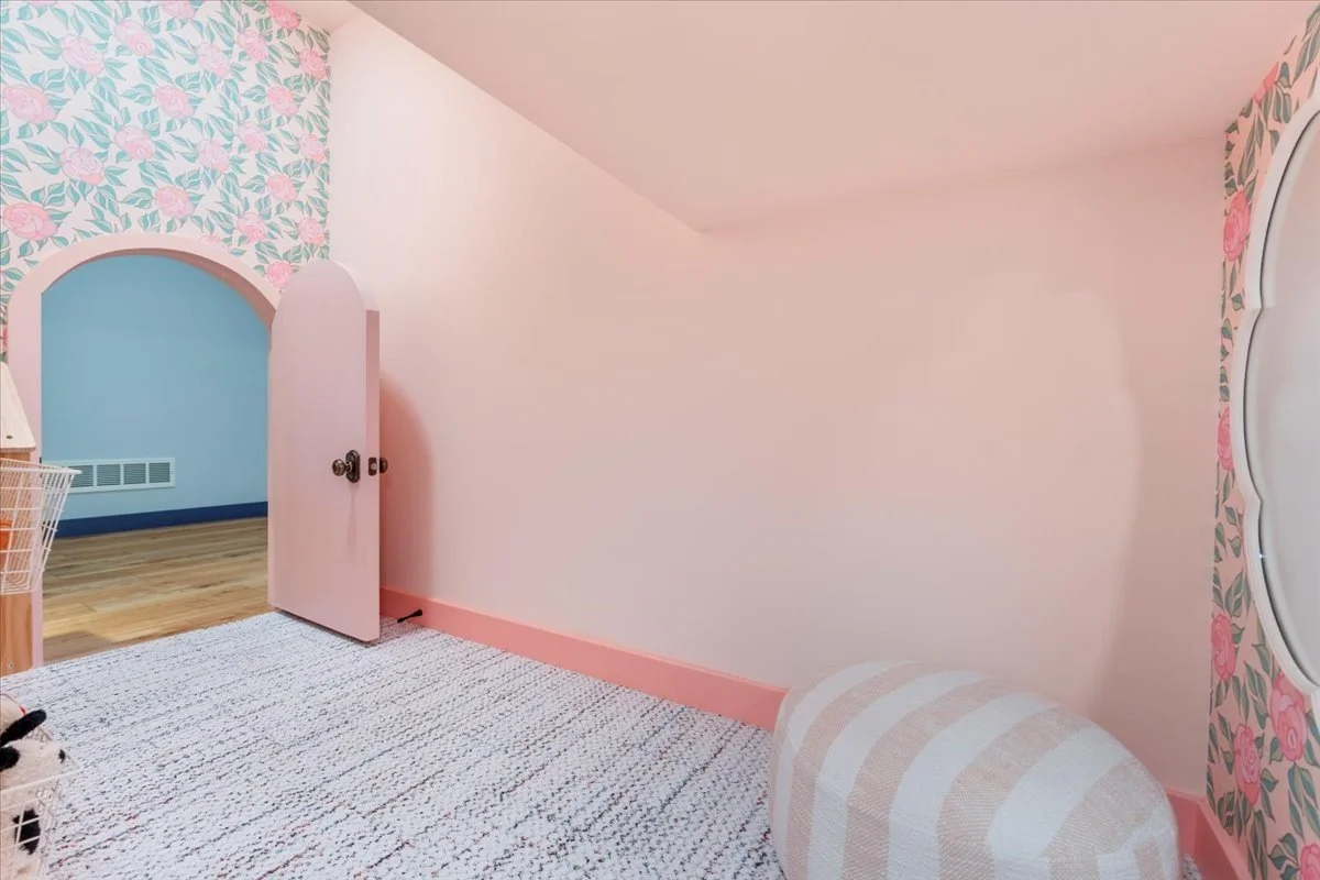 Pink playhouse room with an arched door