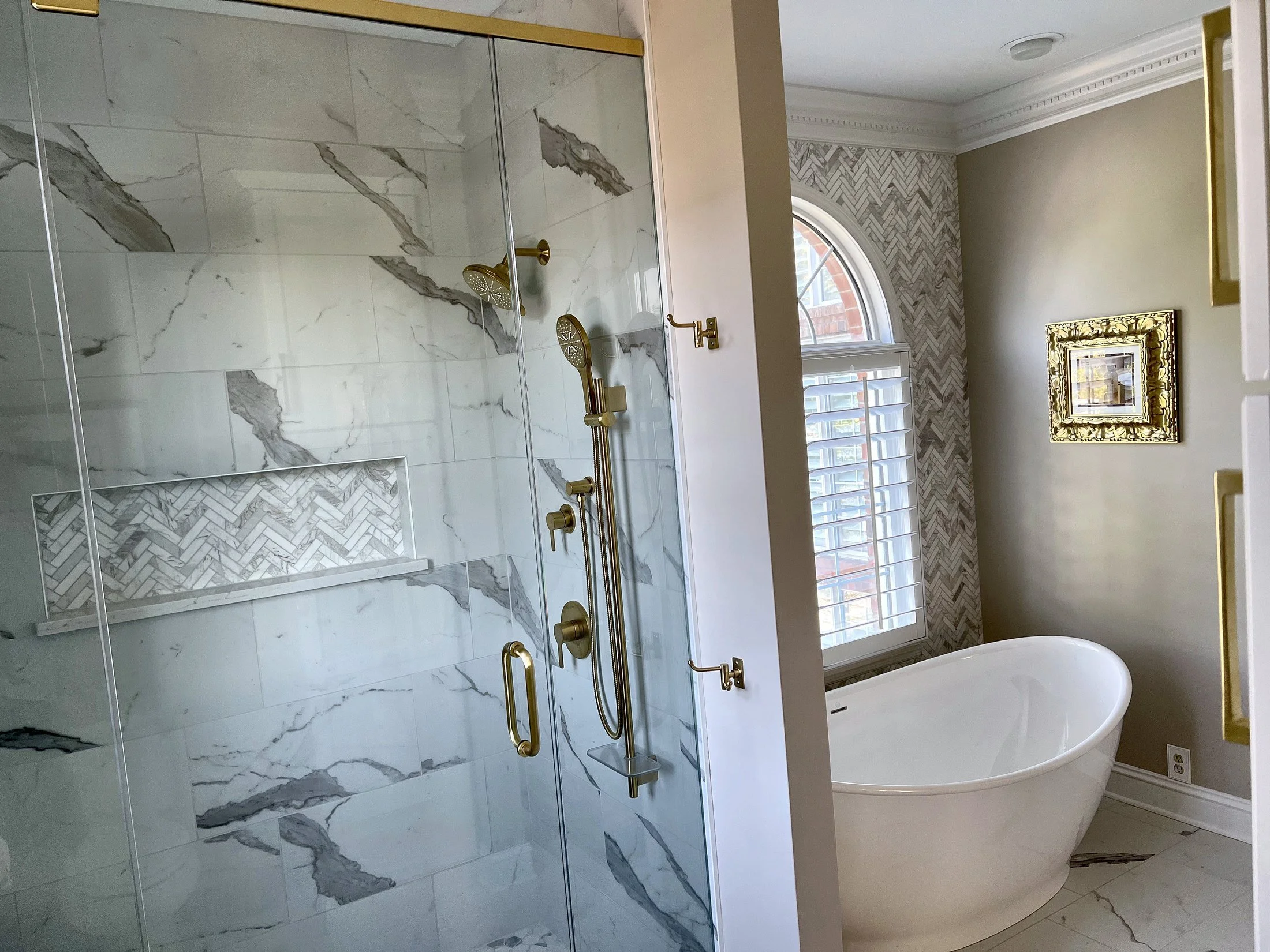 Glass shower beside the freestanding tub