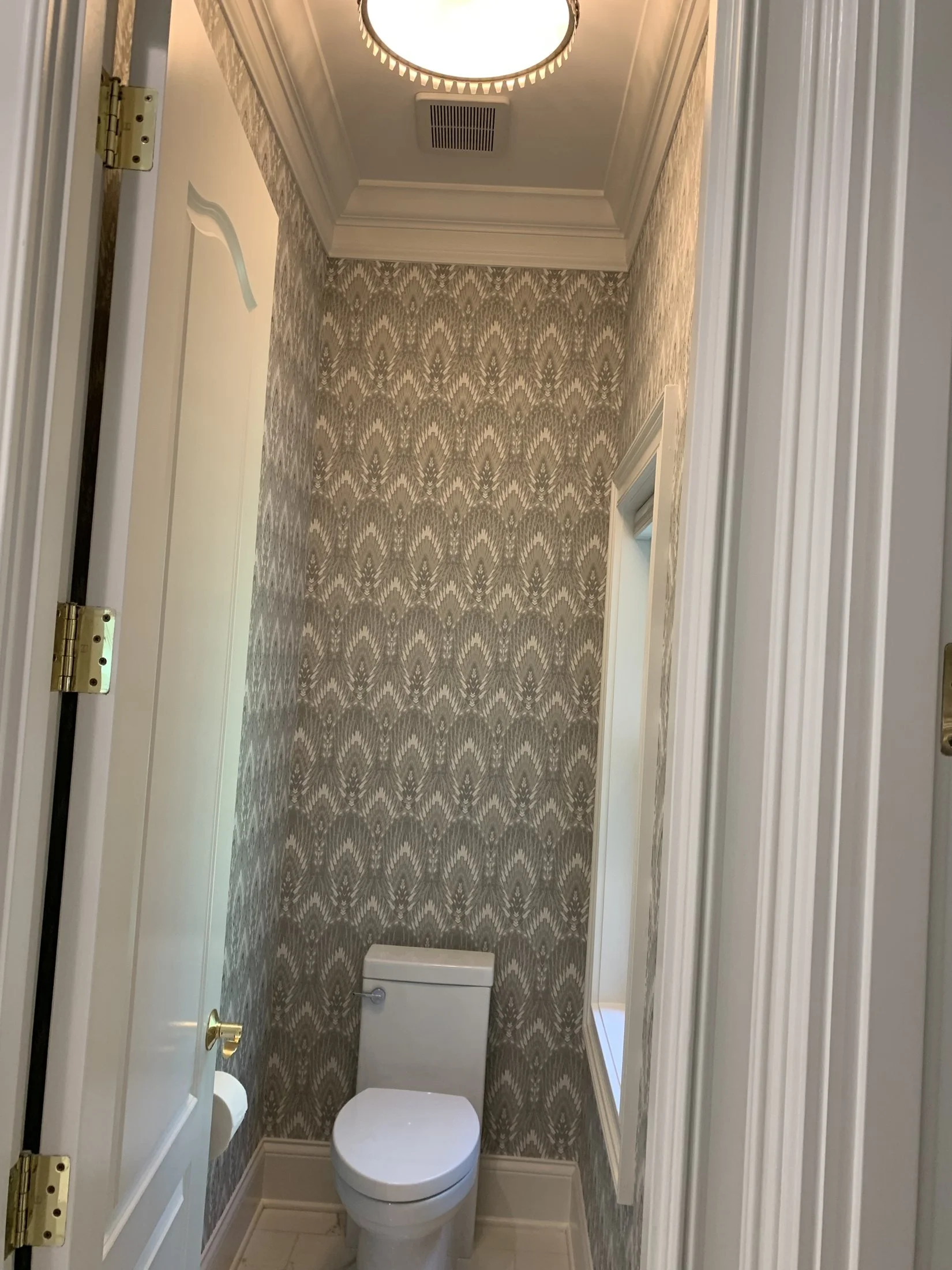 Water closet with a patterned accent wall
