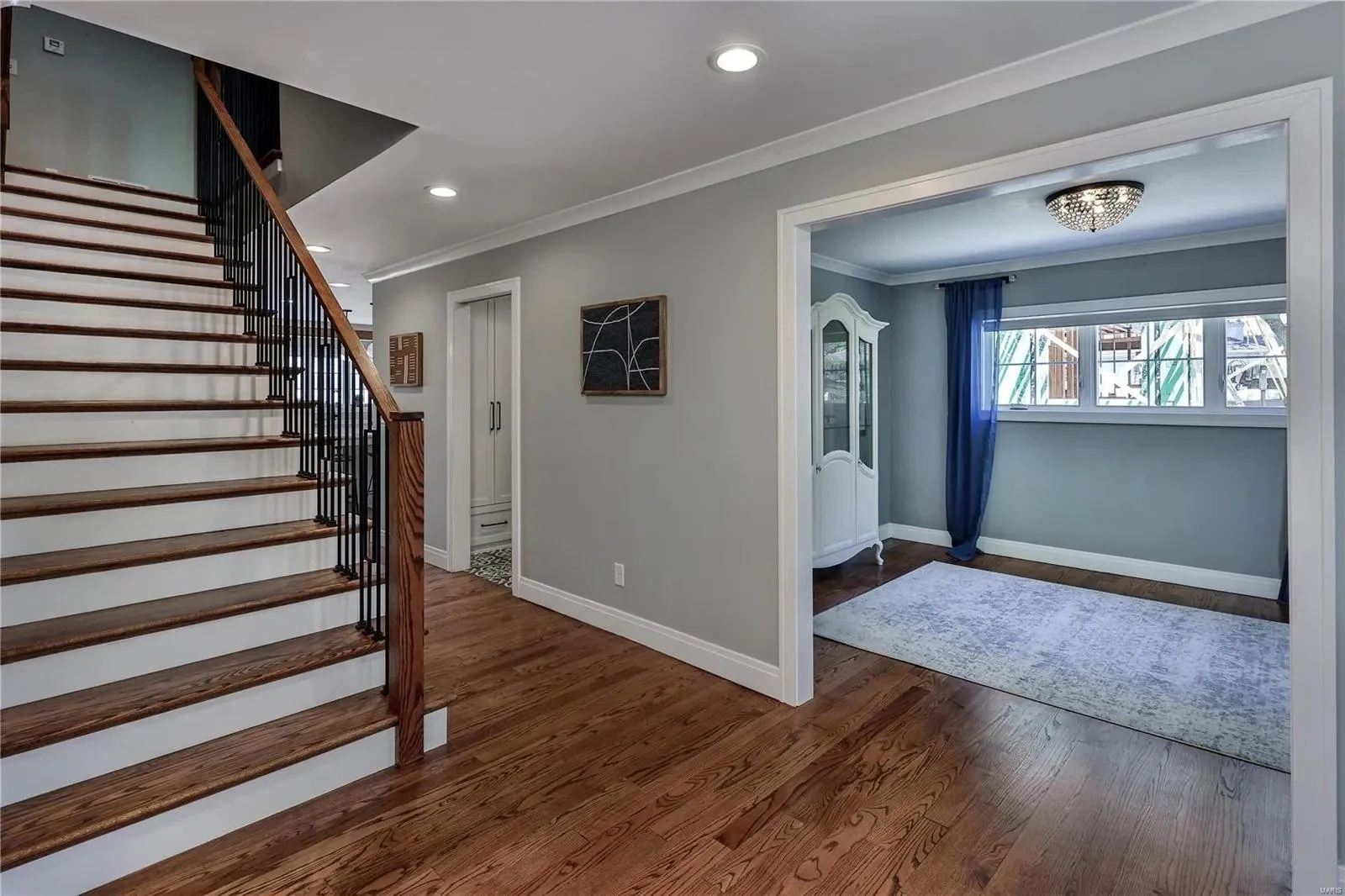 Front hall with a stair and paneled trim