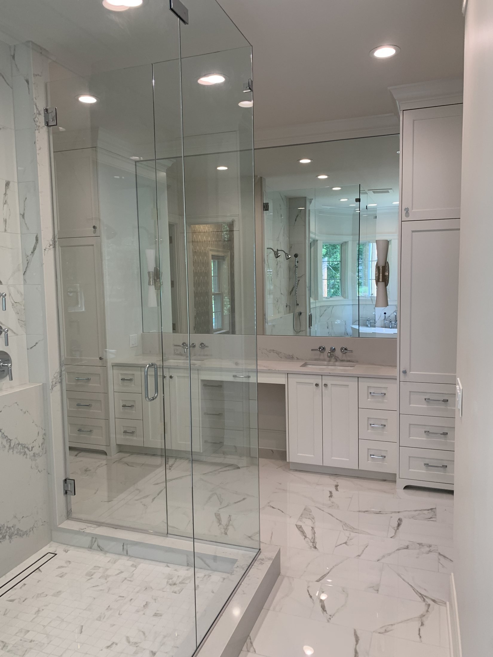 Glass shower and marble-look tile floor