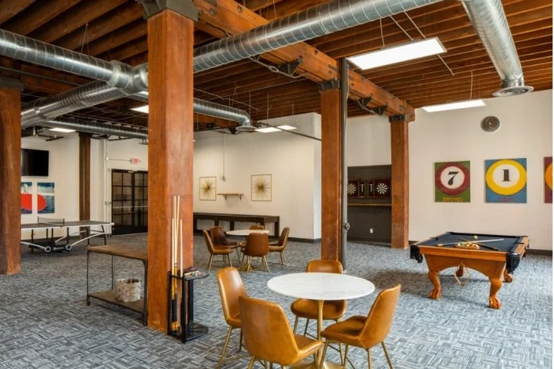 Game room with timber columns and exposed ductwork