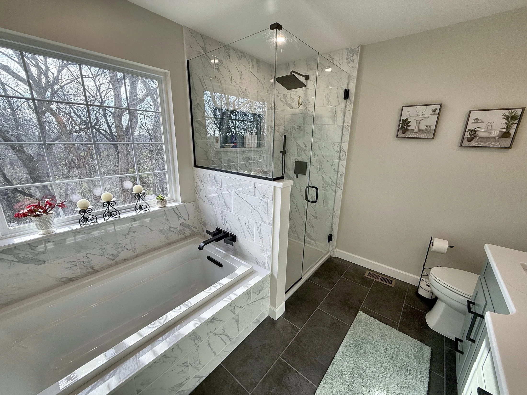 Soaking tub and glass shower under the window