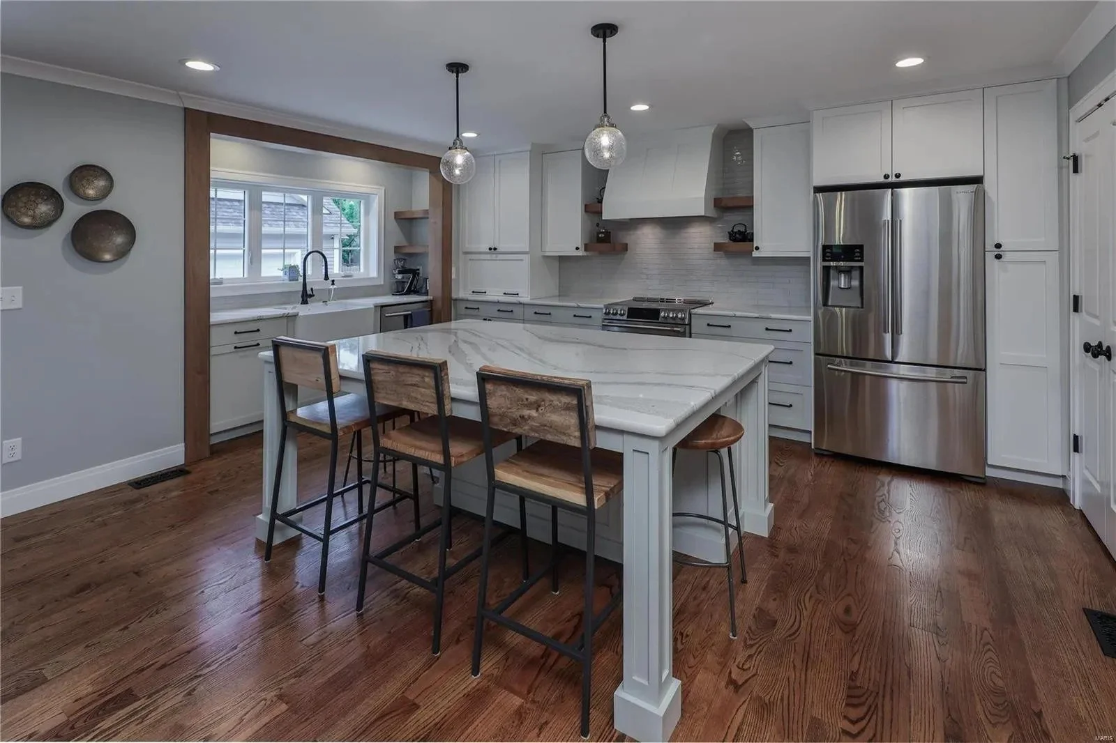 Kitchen with stainless appliances and a quartz island