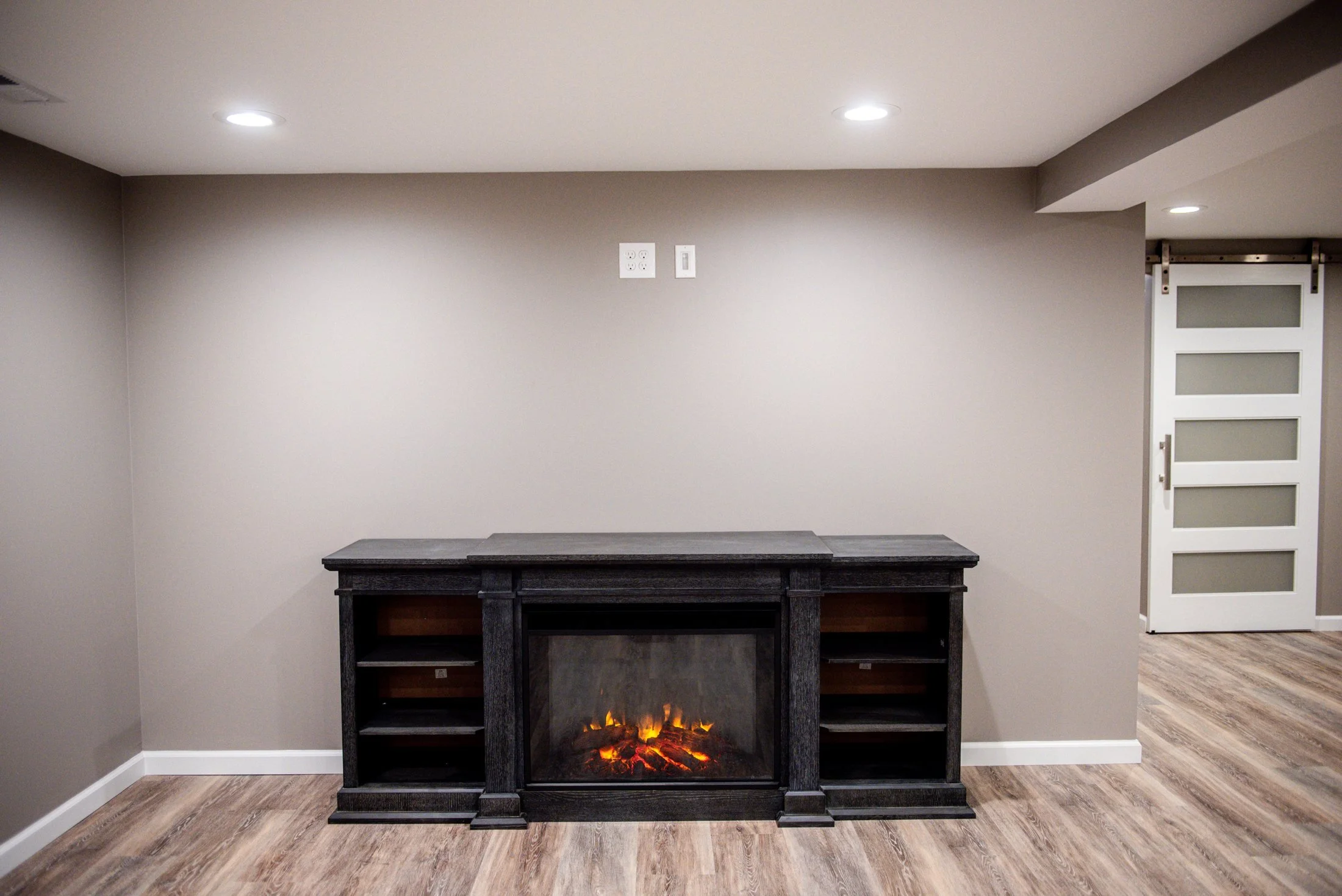 Basement family room with an electric fireplace