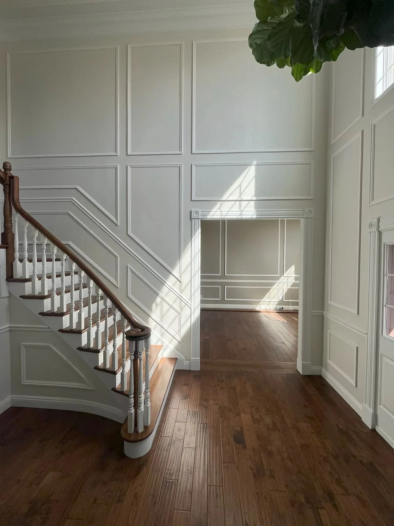 Foyer wall paneling and stair trim in progress